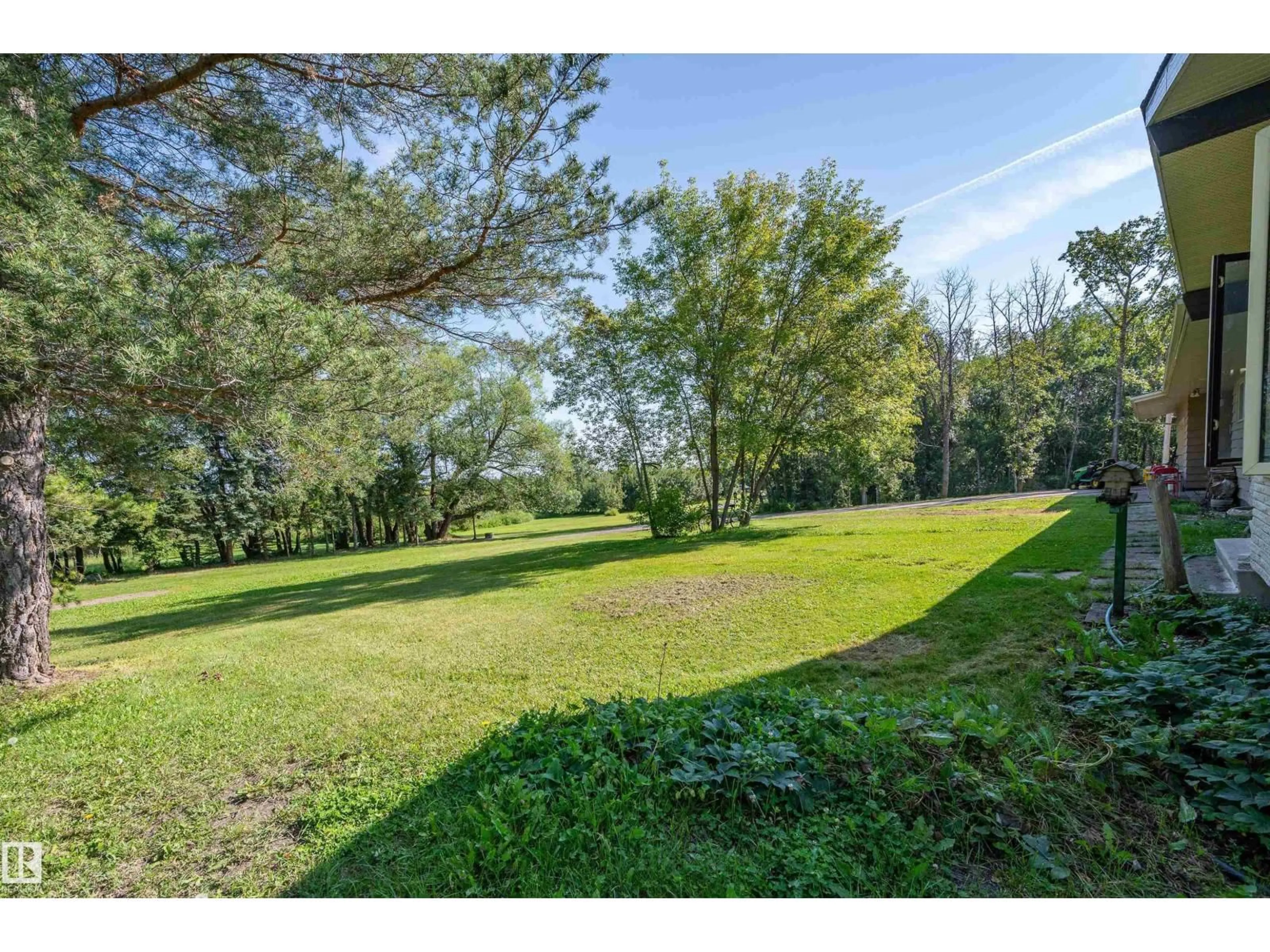 A pic from outside/outdoor area/front of a property/back of a property/a pic from drone, forest/trees view for 109 - 52312 RGE ROAD 223, Rural Strathcona County Alberta T8C1B3