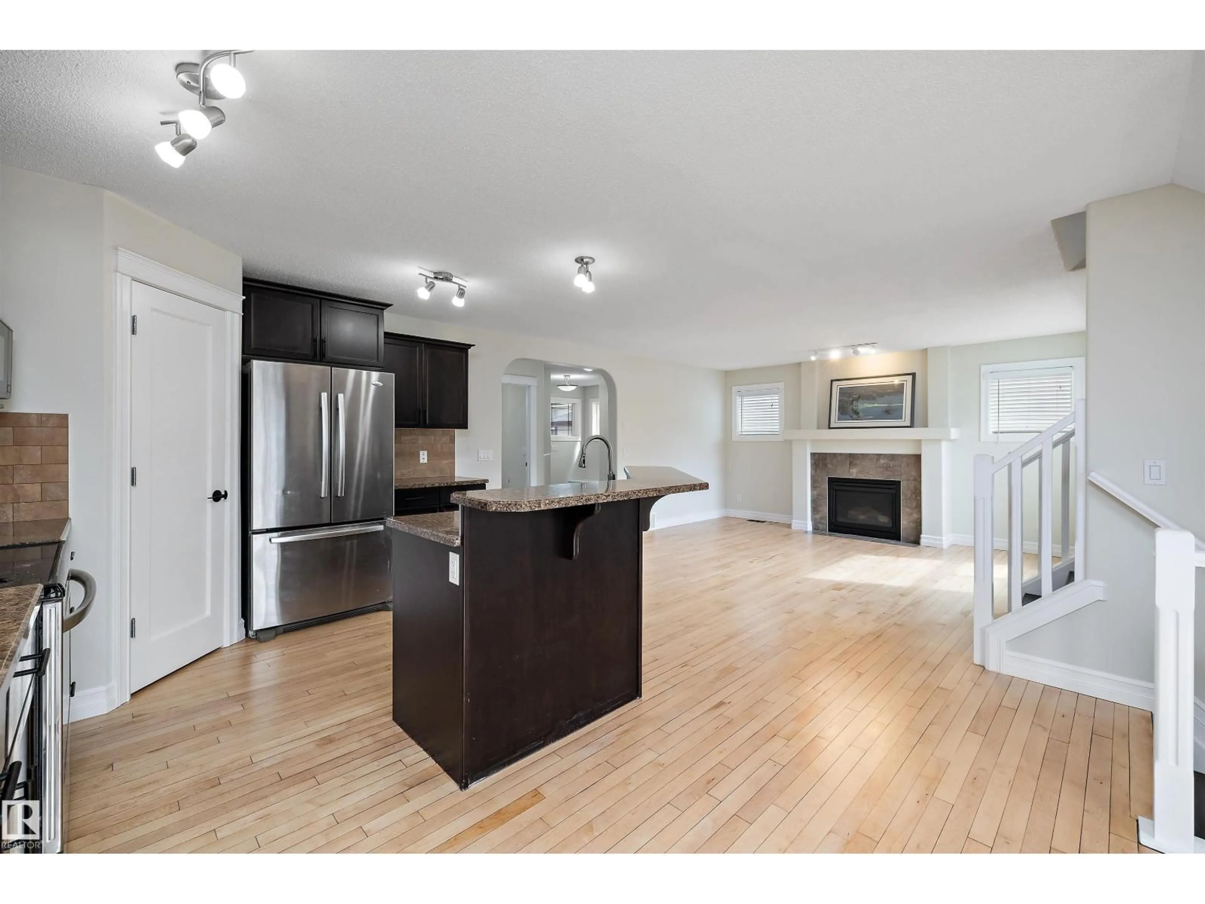 Open concept kitchen, wood/laminate floor for 178 WOODBEND WY, Fort Saskatchewan Alberta T8L4S4