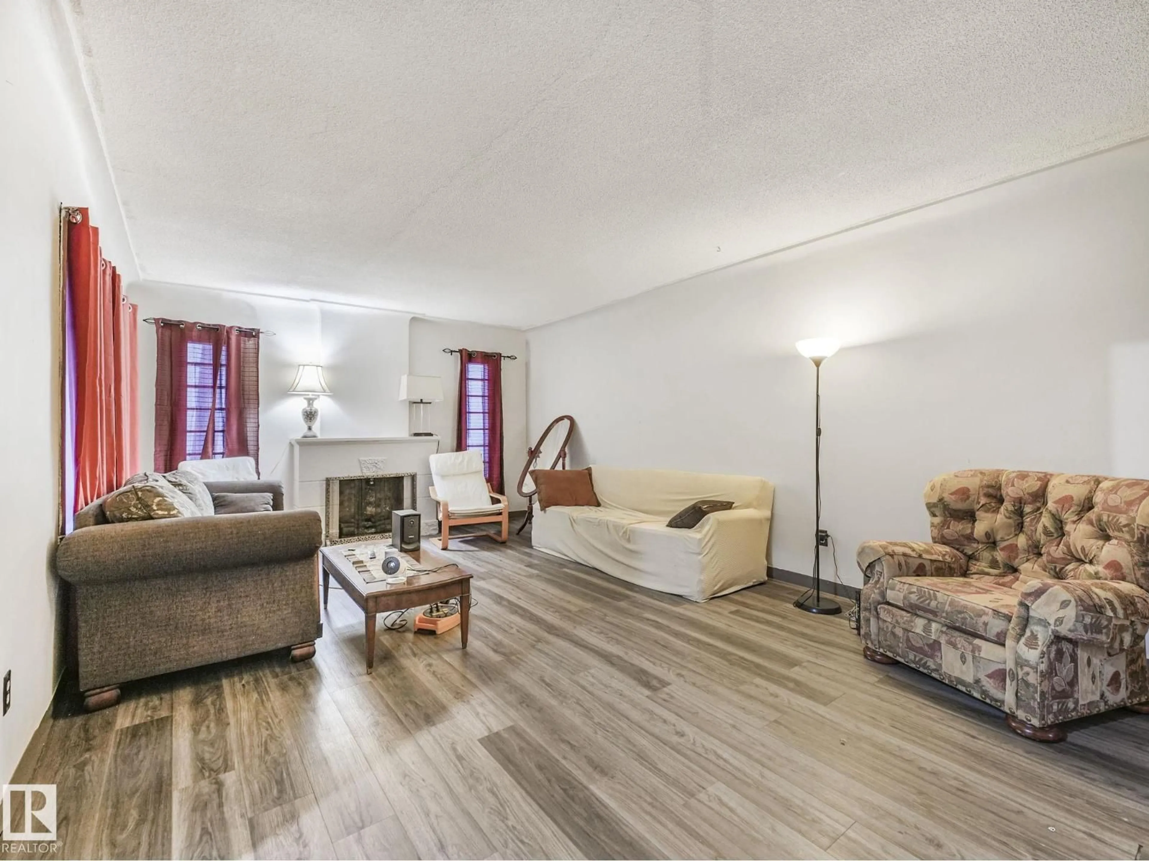 Living room with furniture, wood/laminate floor for NW - 10948 108 ST, Edmonton Alberta T5H3A7