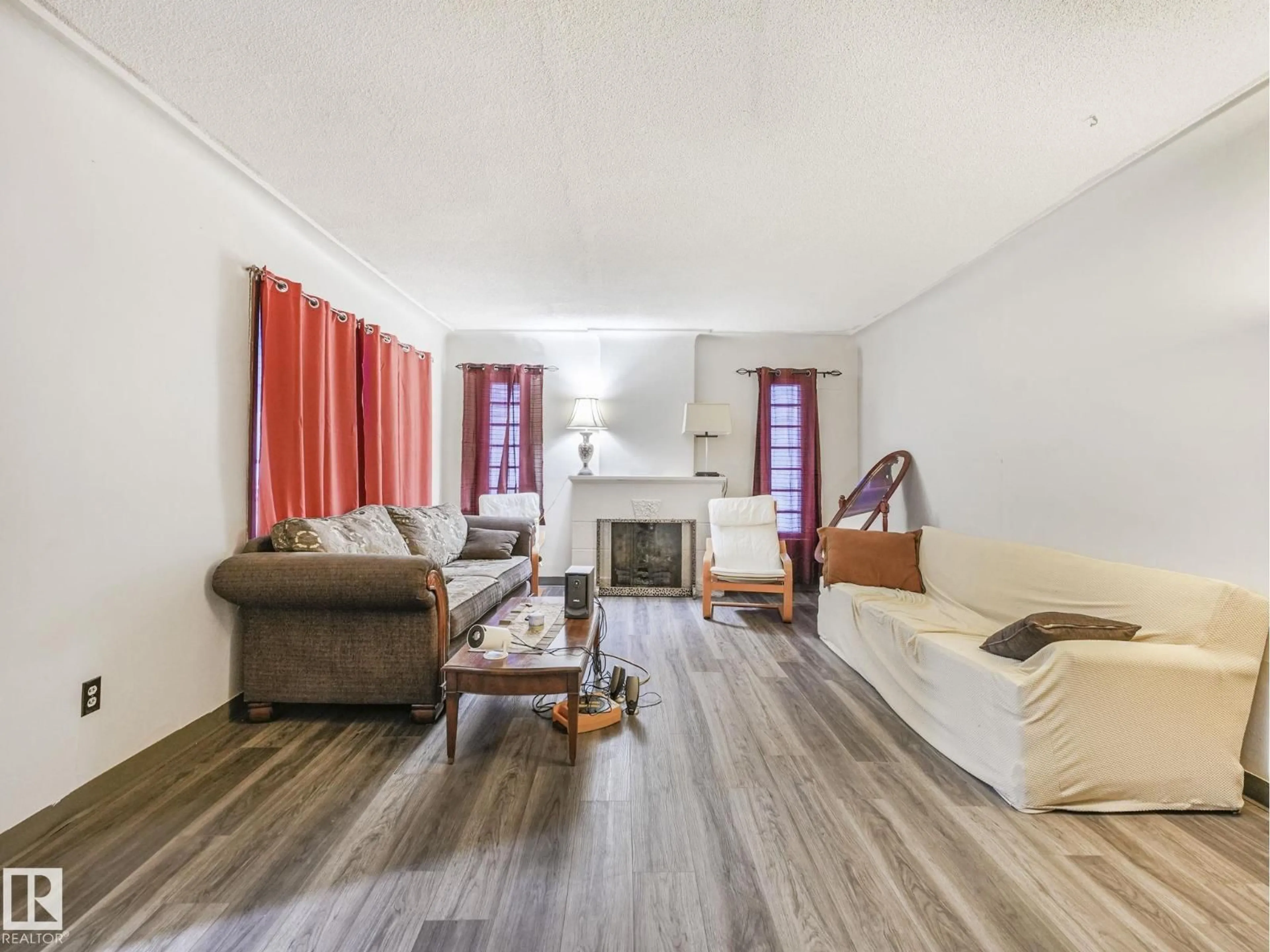 Living room with furniture, wood/laminate floor for NW - 10948 108 ST, Edmonton Alberta T5H3A7
