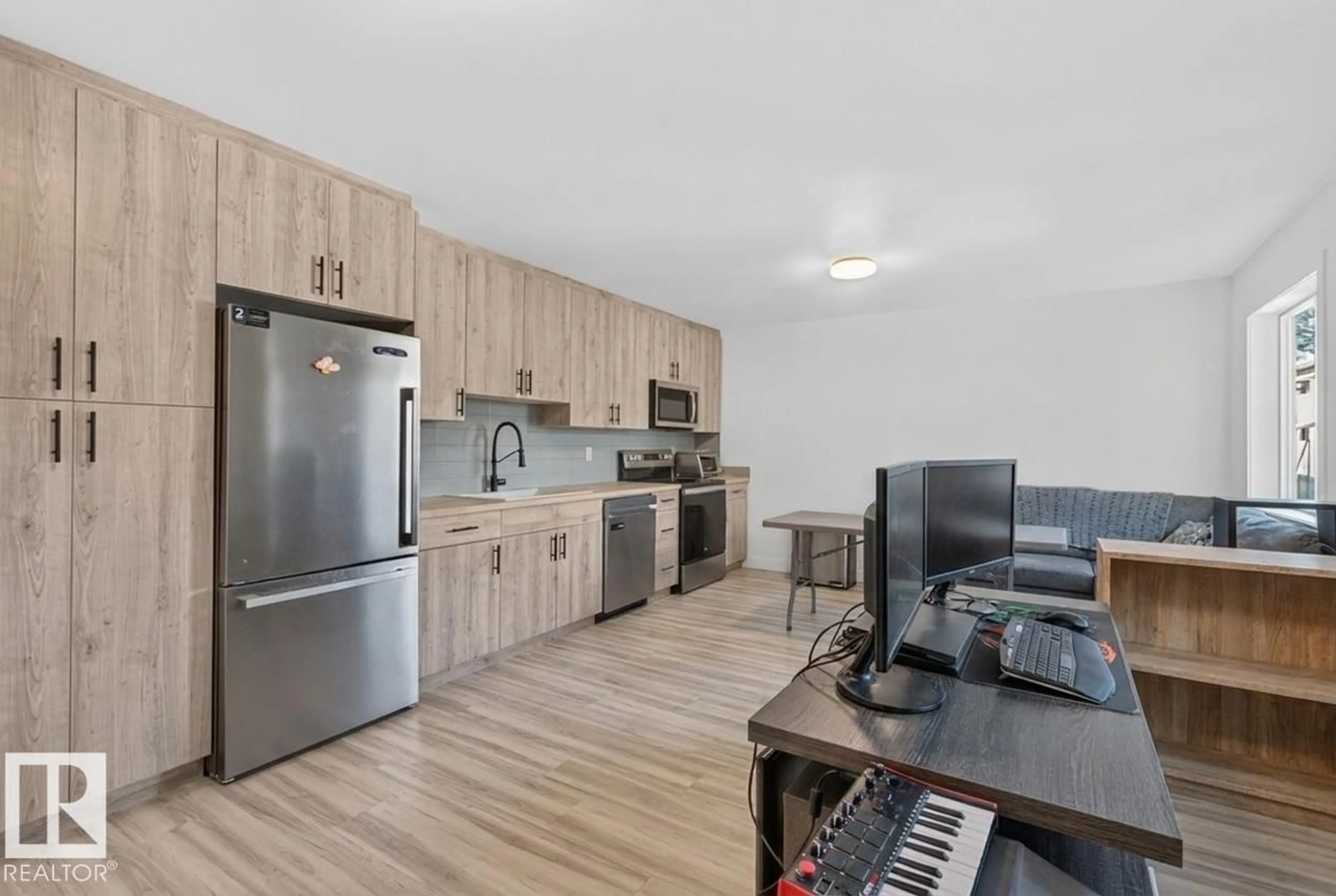 Open concept kitchen, wood/laminate floor for 10726 107 ST, Edmonton Alberta T5H2Z1