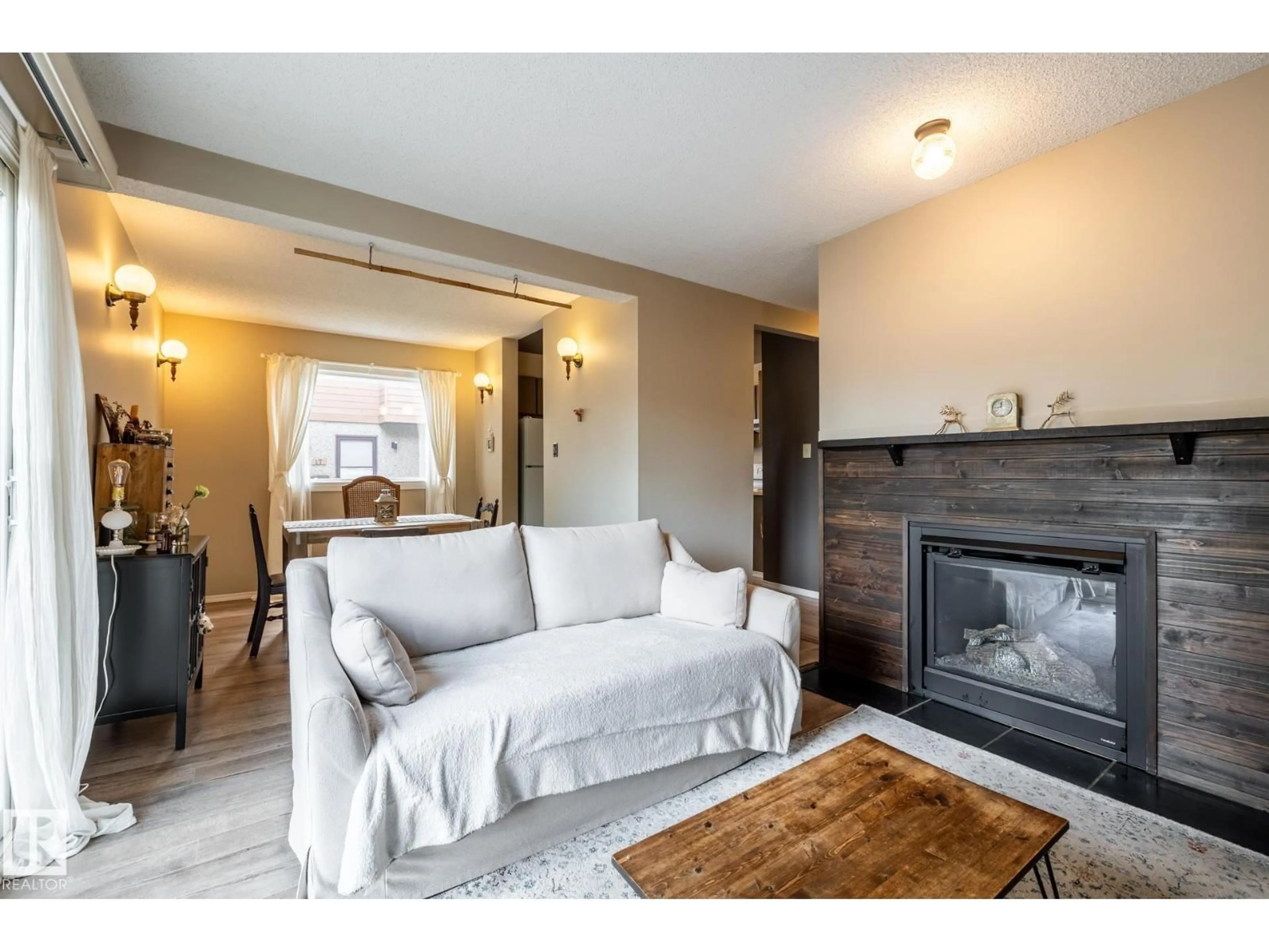 Living room with furniture, wood/laminate floor for 20 3812 20 AV NW, Edmonton Alberta T6L4B2