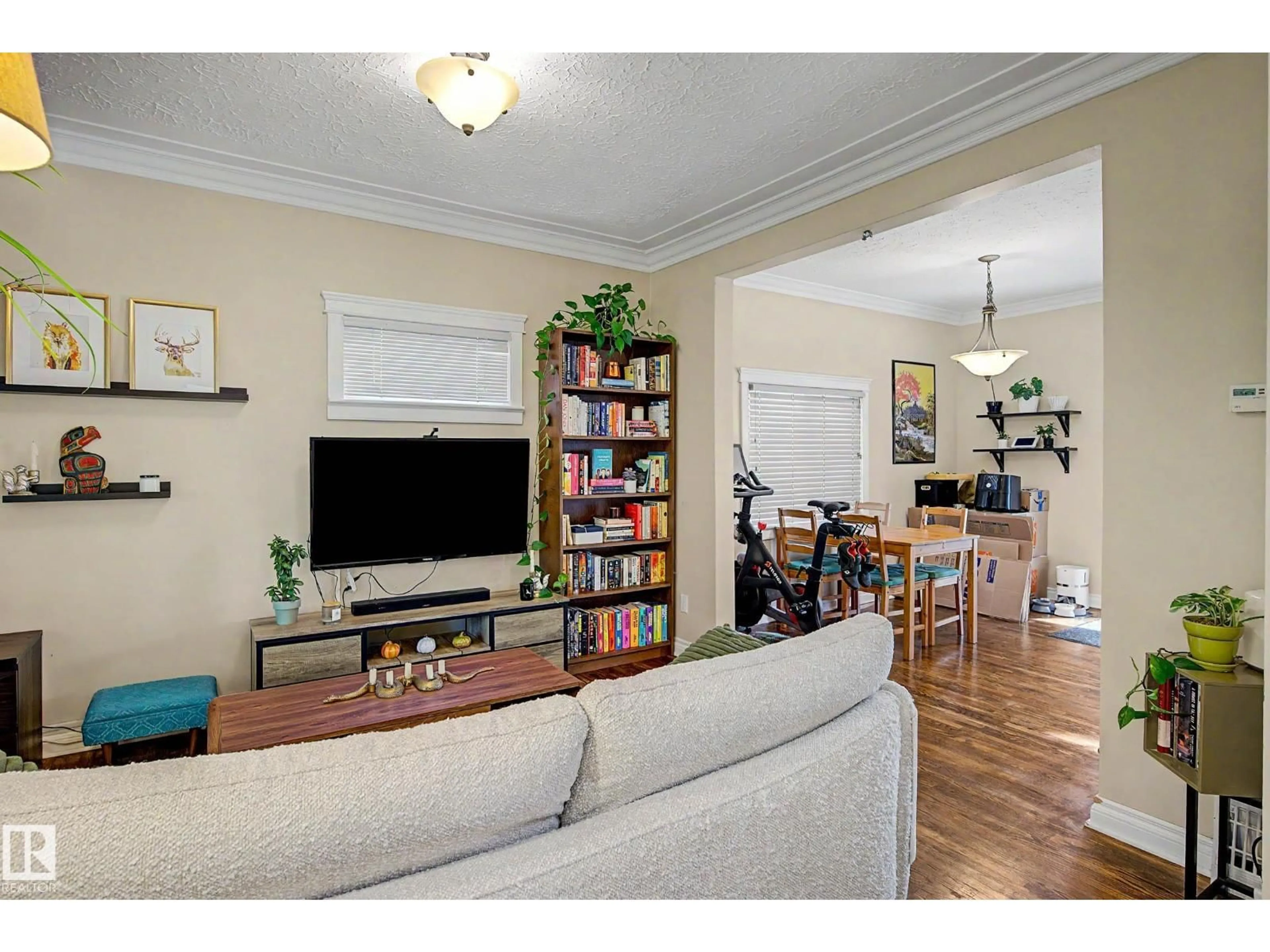 Living room with furniture, wood/laminate floor for 11247 88 ST, Edmonton Alberta T5B3P6