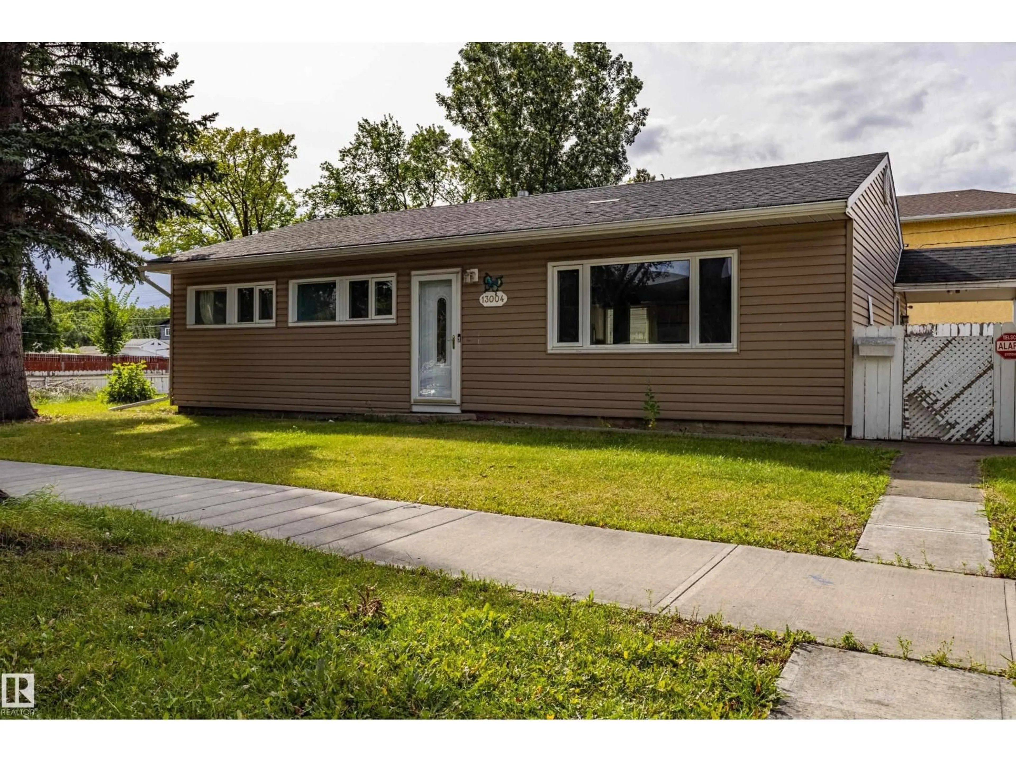 Home with vinyl exterior material, street for 13004 114 ST, Edmonton Alberta T5E5C9