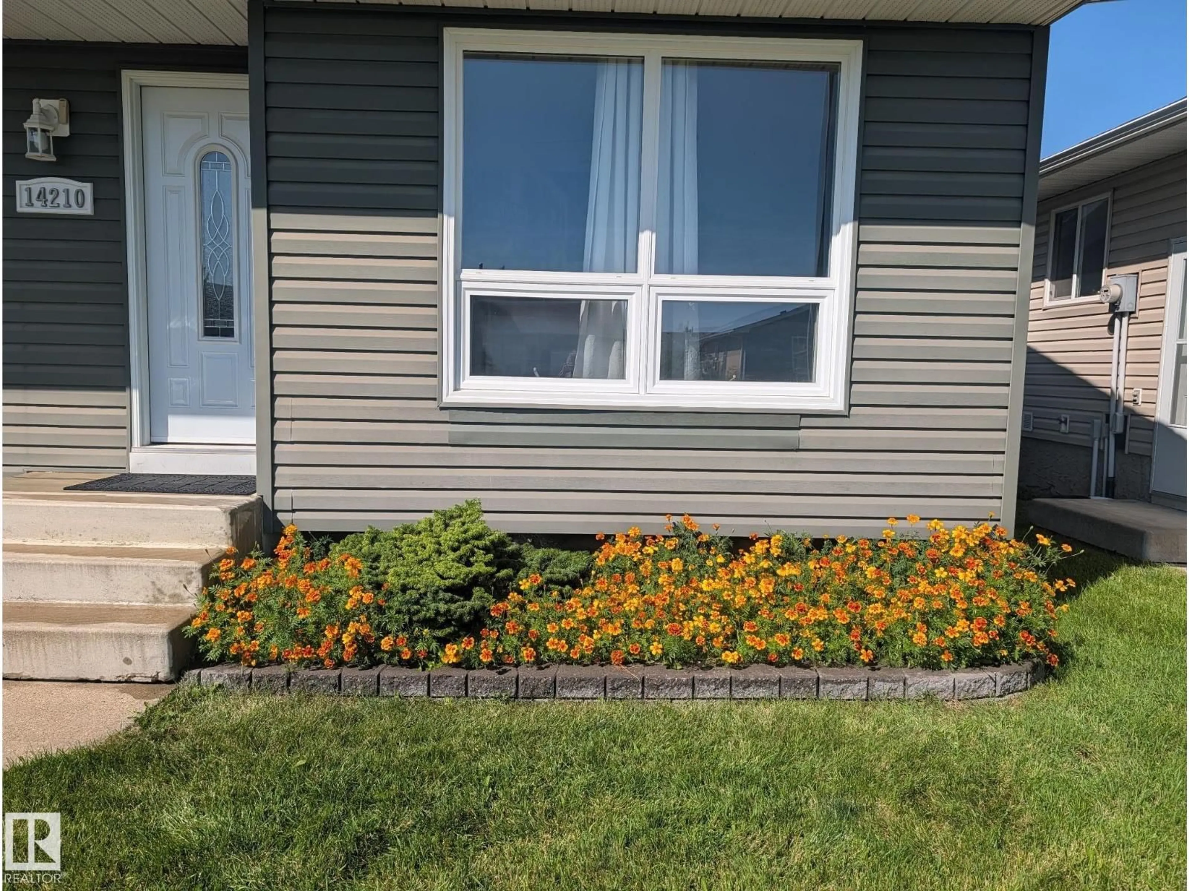 Home with vinyl exterior material, street for 14210 22A ST NW, Edmonton Alberta T5Y1E1