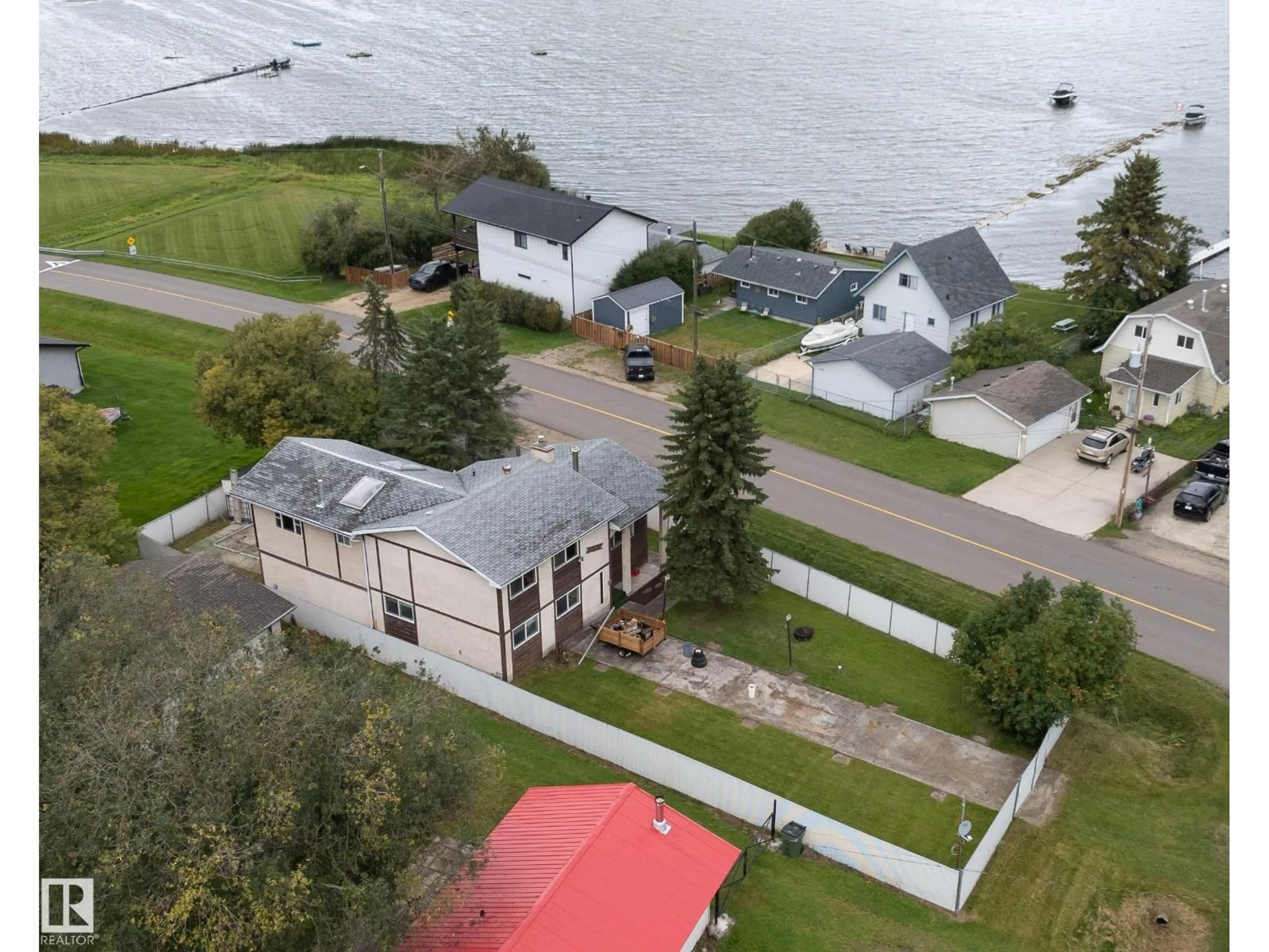 A pic from outside/outdoor area/front of a property/back of a property/a pic from drone, water/lake/river/ocean view for 5039 64 ST, Rural Lac Ste. Anne County Alberta T0E0A0