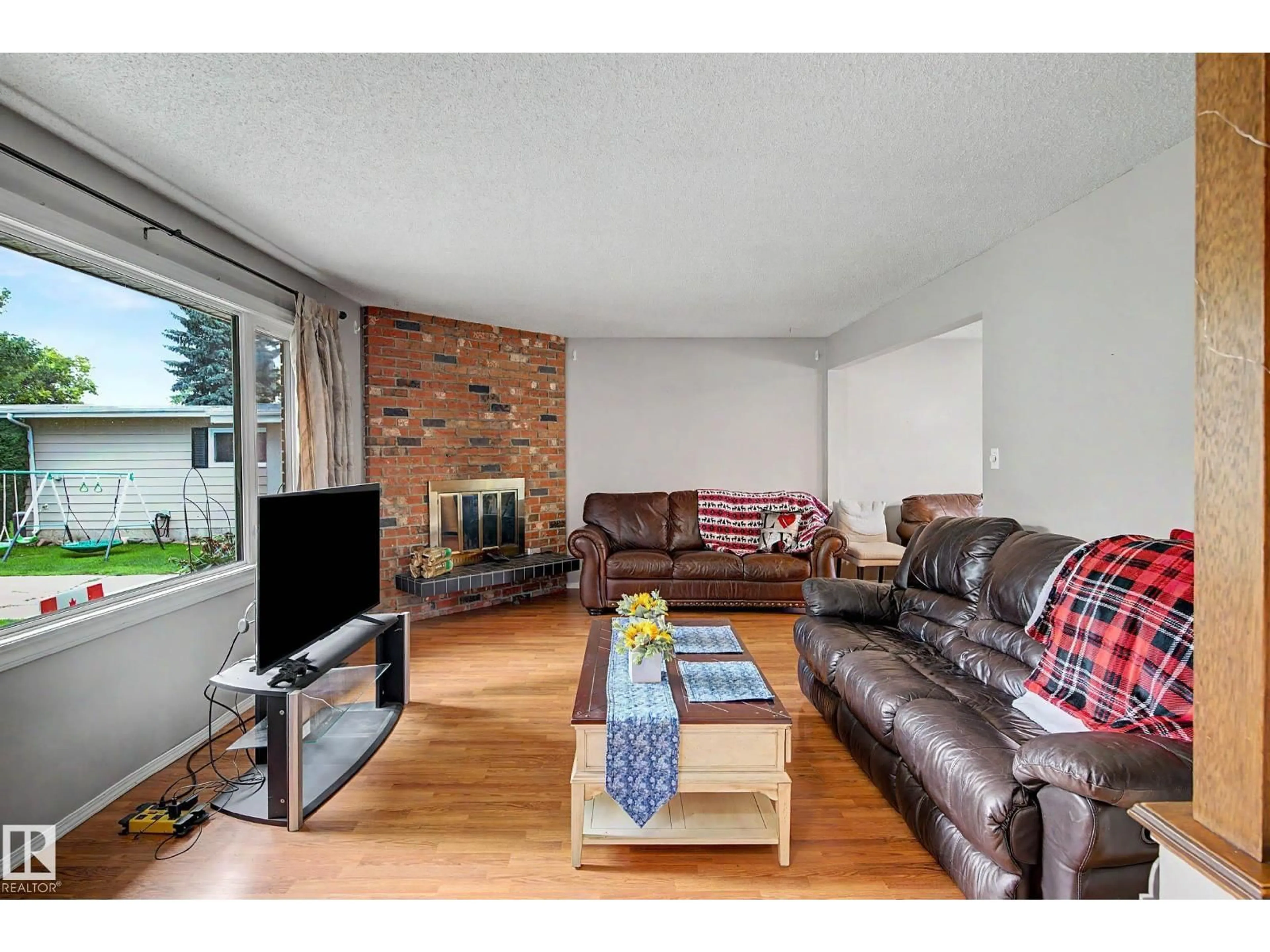 Living room with furniture, wood/laminate floor for 23 MONTCALM CR, St. Albert Alberta T8N2C8
