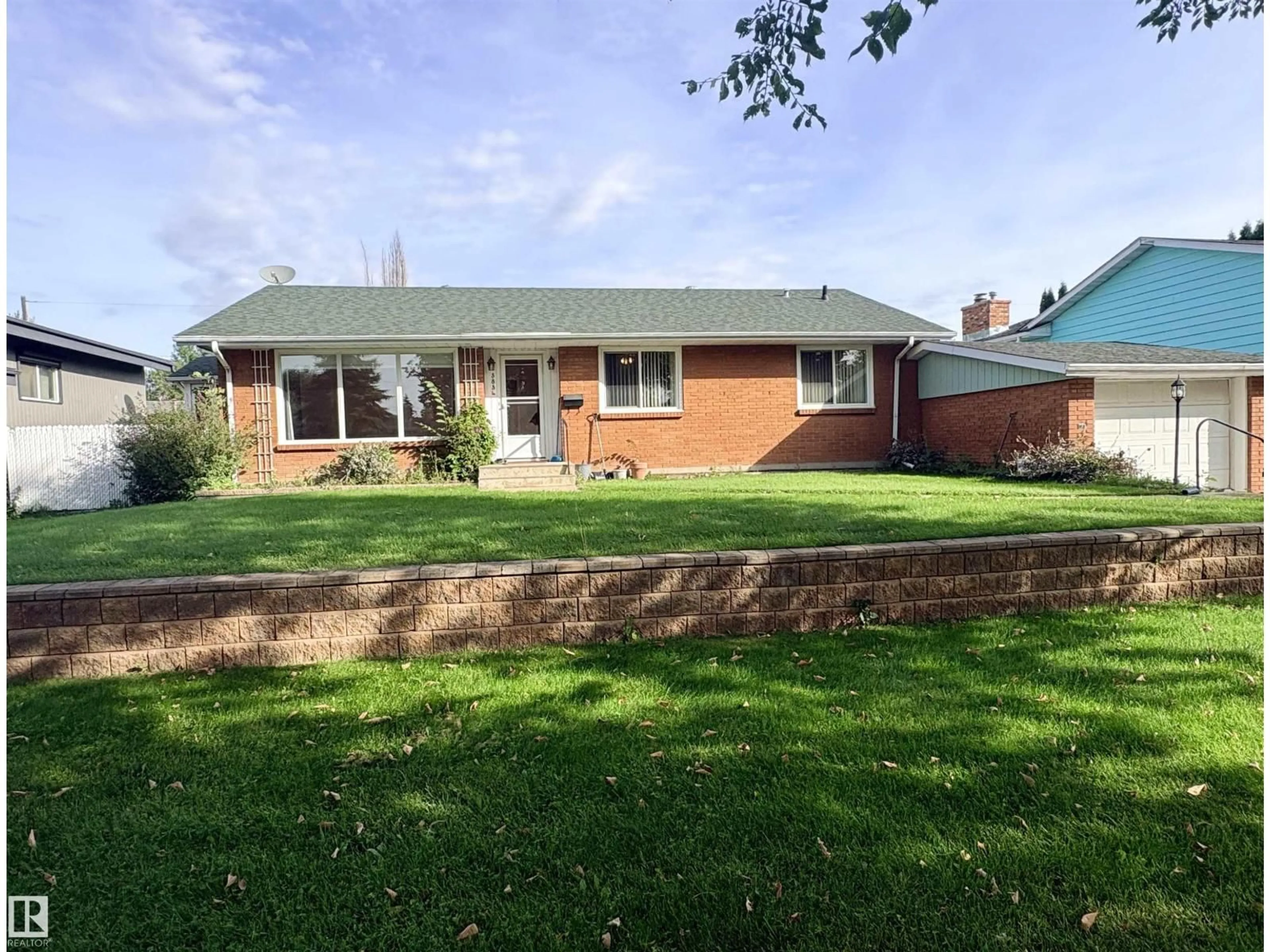Home with brick exterior material, street for 3834 110 AV, Edmonton Alberta T5W0H7