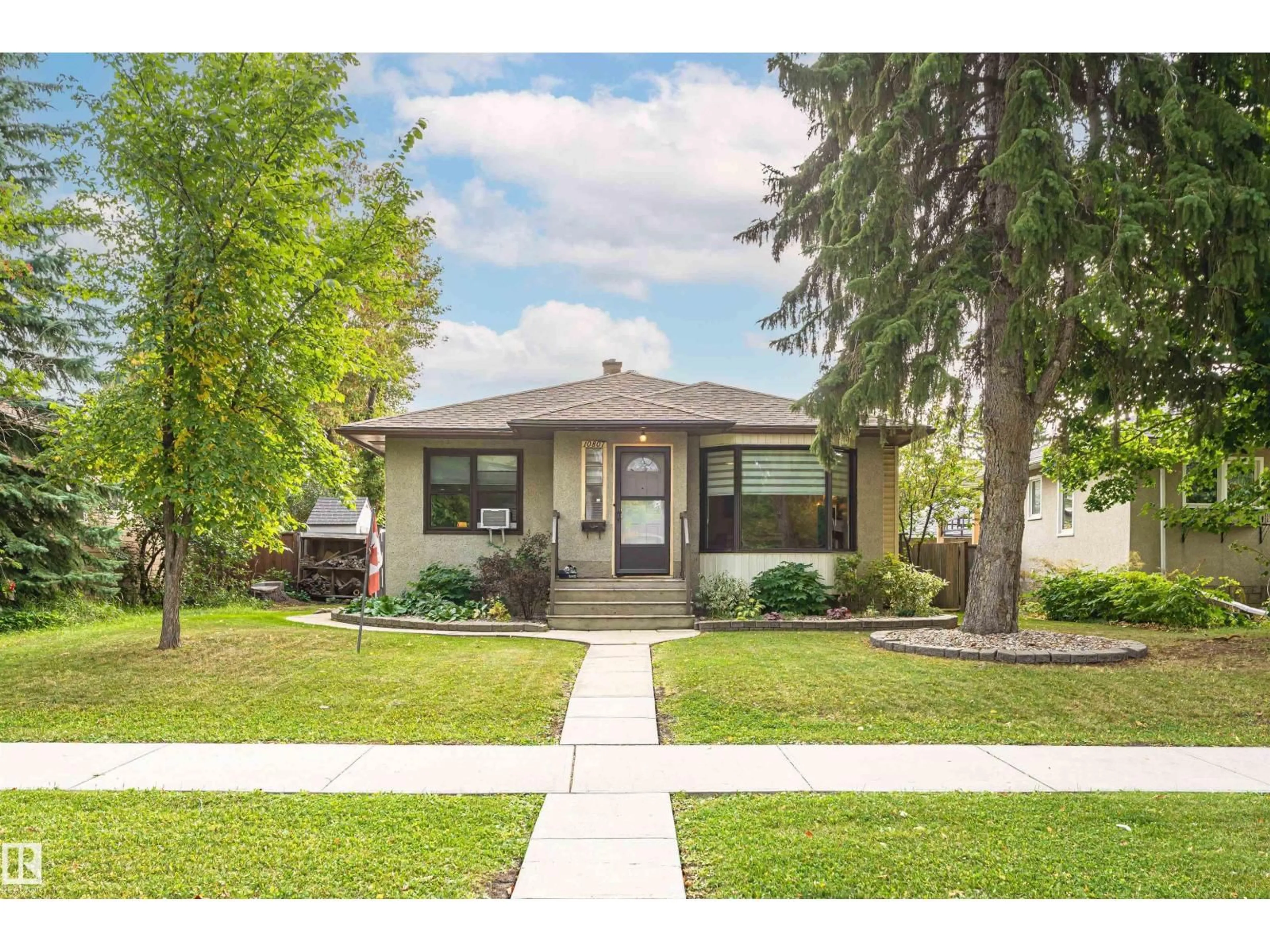 Home with vinyl exterior material, street for NW - 10807 136 ST, Edmonton Alberta T5M1M1