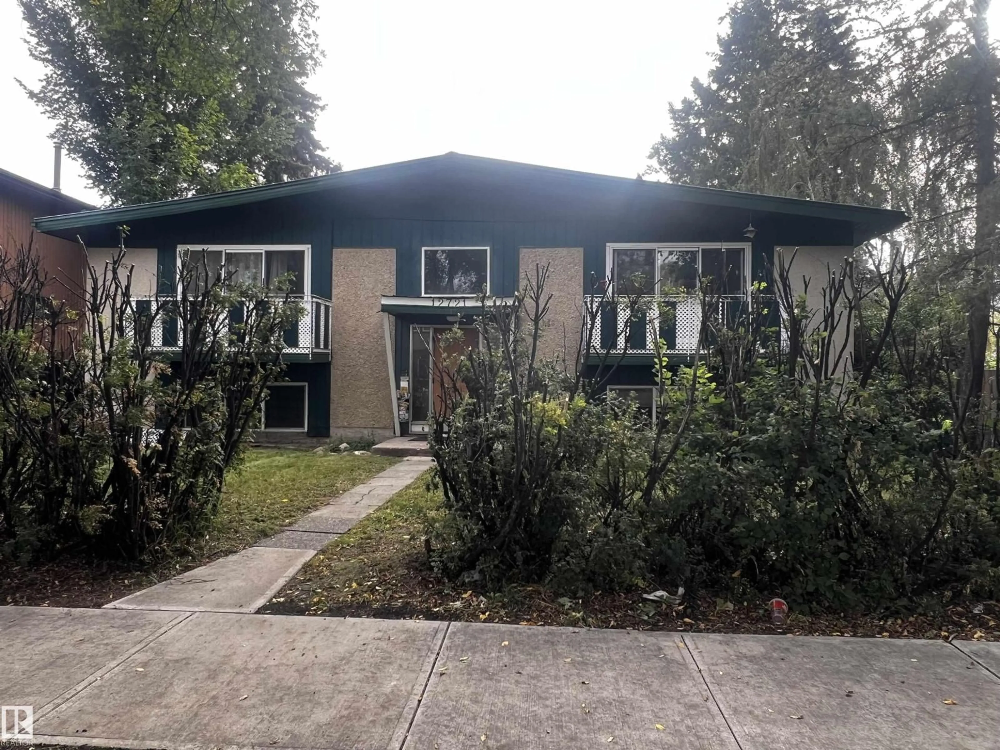 Home with vinyl exterior material, street for 12719 118 ST, Edmonton Alberta T5E5K9