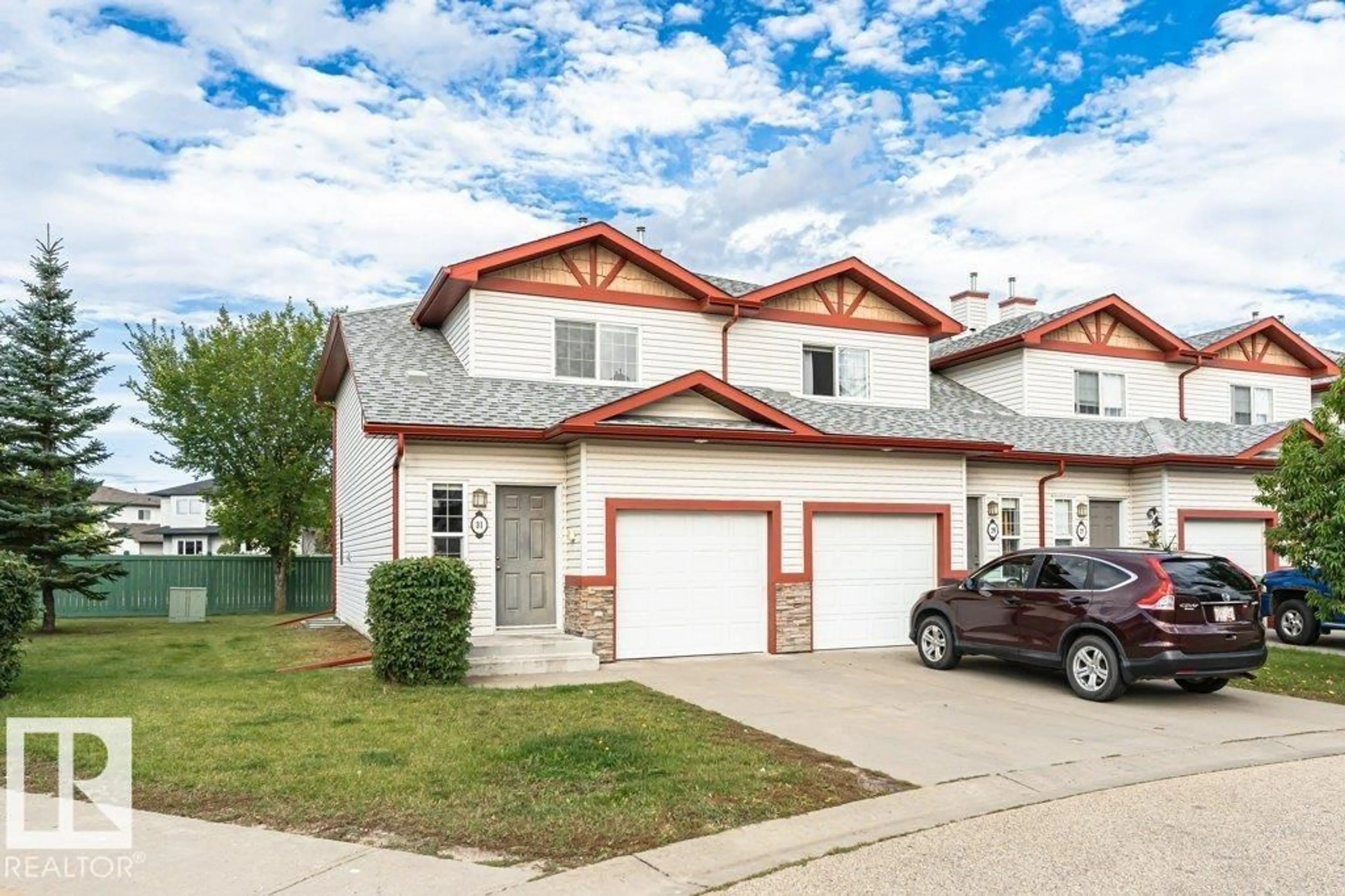 Home with vinyl exterior material, street for 15 - 31 WOODSMERE CL, Fort Saskatchewan Alberta T8L4S2