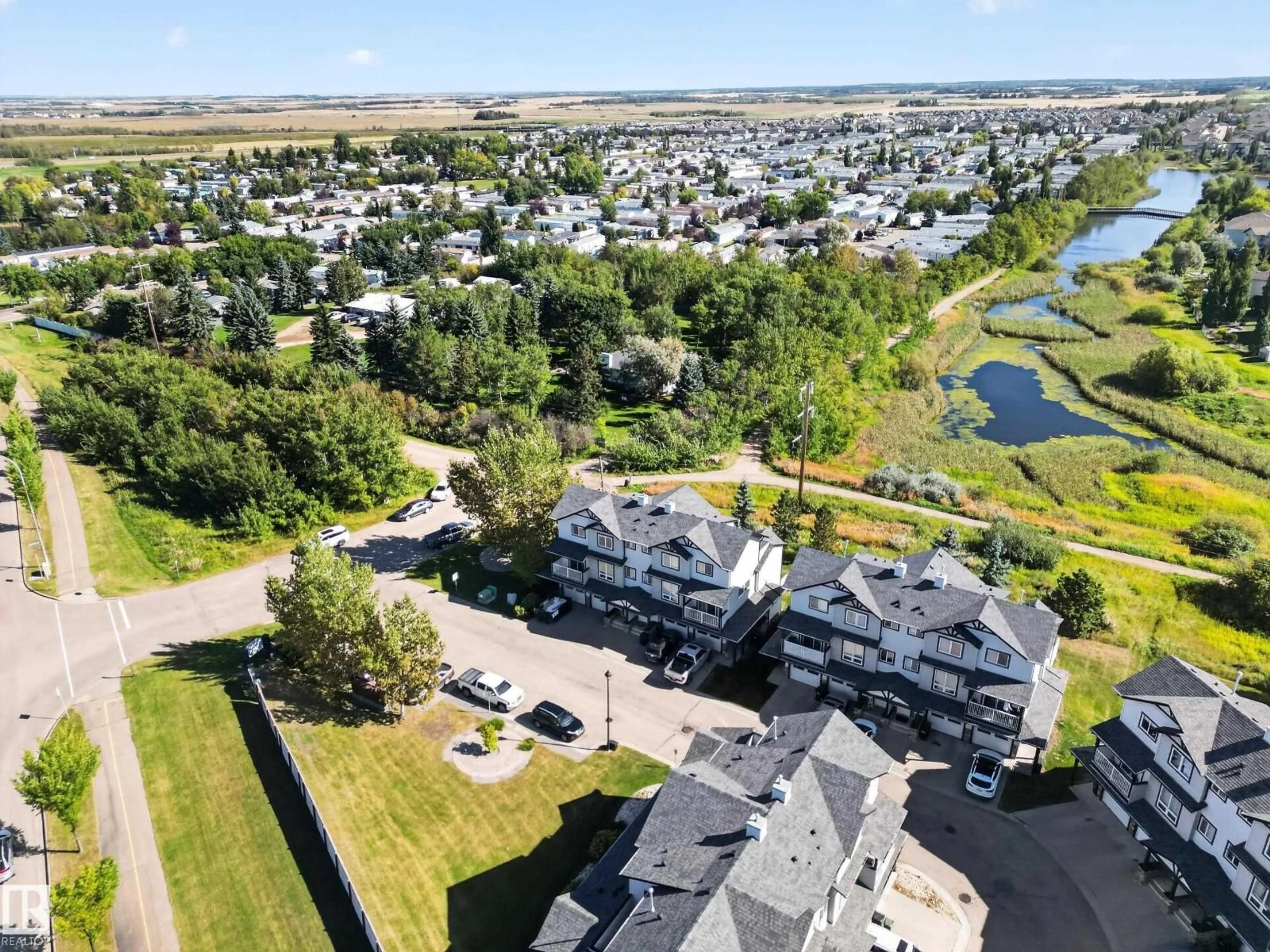 A pic from outside/outdoor area/front of a property/back of a property/a pic from drone, water/lake/river/ocean view for 11 - 3 CLOVER BAR LN, Sherwood Park Alberta T8H0C4
