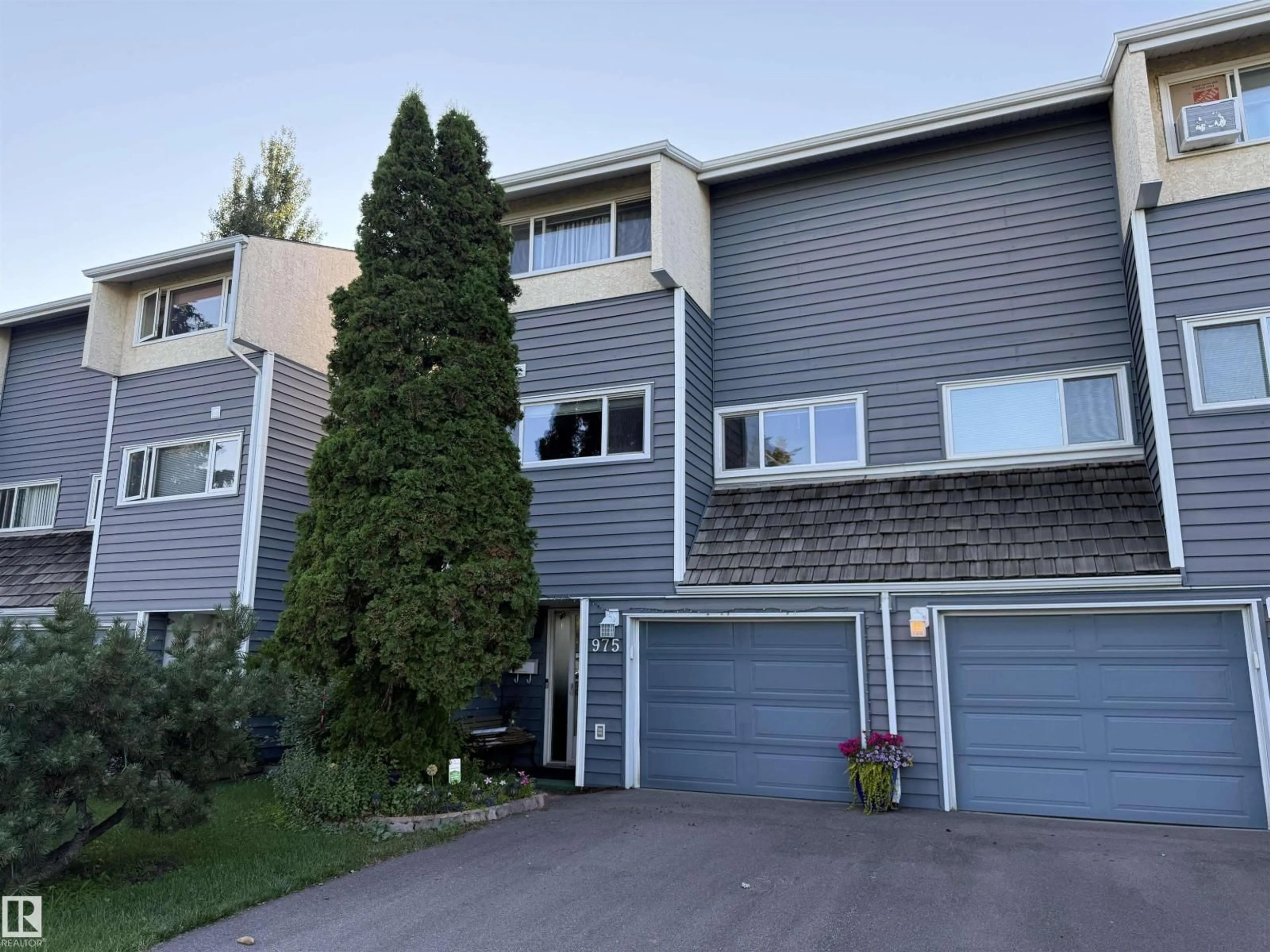 Home with vinyl exterior material, street for 975 MILLBOURNE RD E RD, Edmonton Alberta T6K0T2