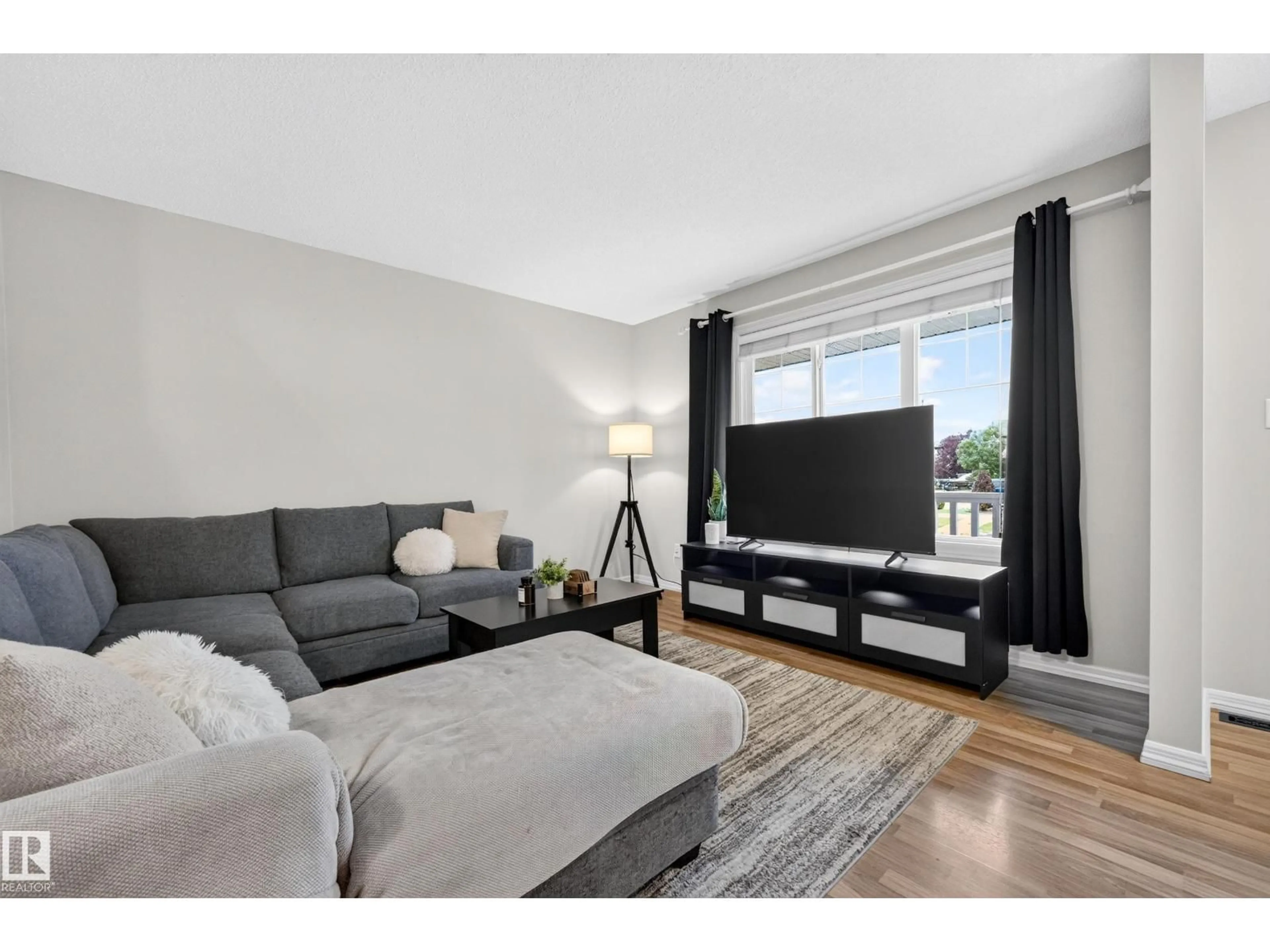 Living room with furniture, wood/laminate floor for 44 ALLARD WY, Fort Saskatchewan Alberta T8L0E6