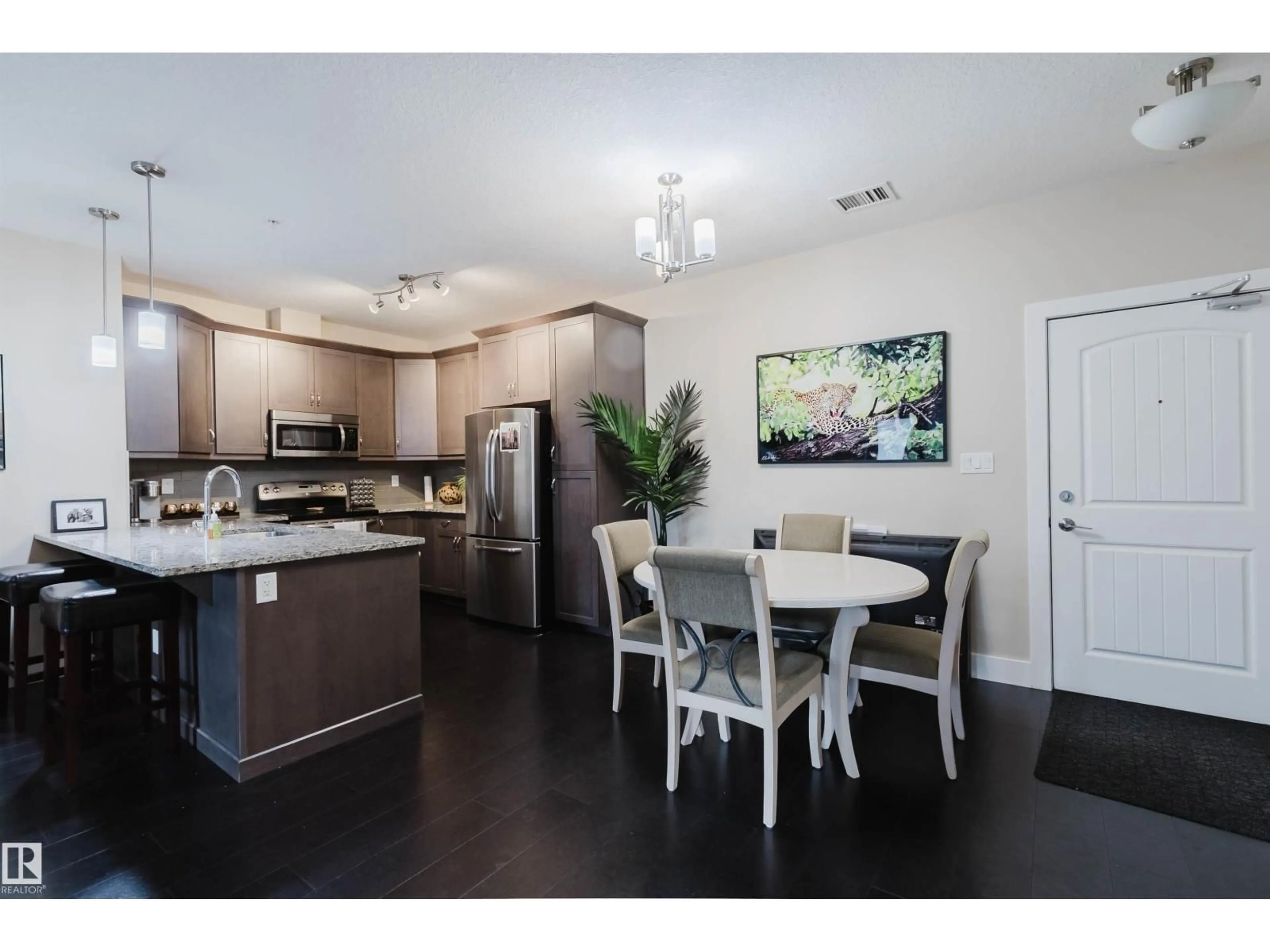 Open concept kitchen, wood/laminate floor for 6079 - 142 MAYNARD WY, Edmonton Alberta T6R0S4