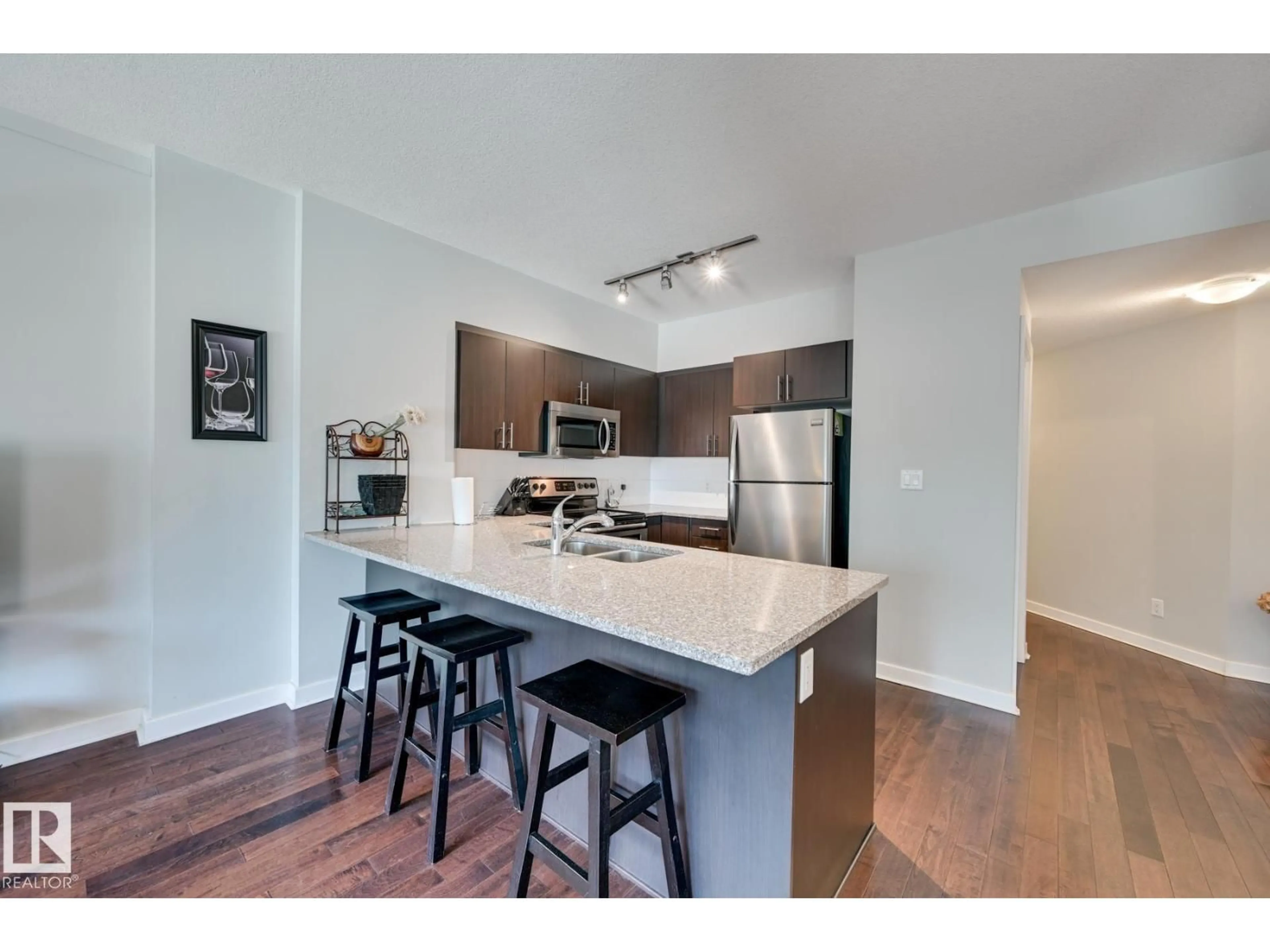 Open concept kitchen, wood/laminate floor for #802 - 10152 104 ST NW, Edmonton Alberta T5J0B6