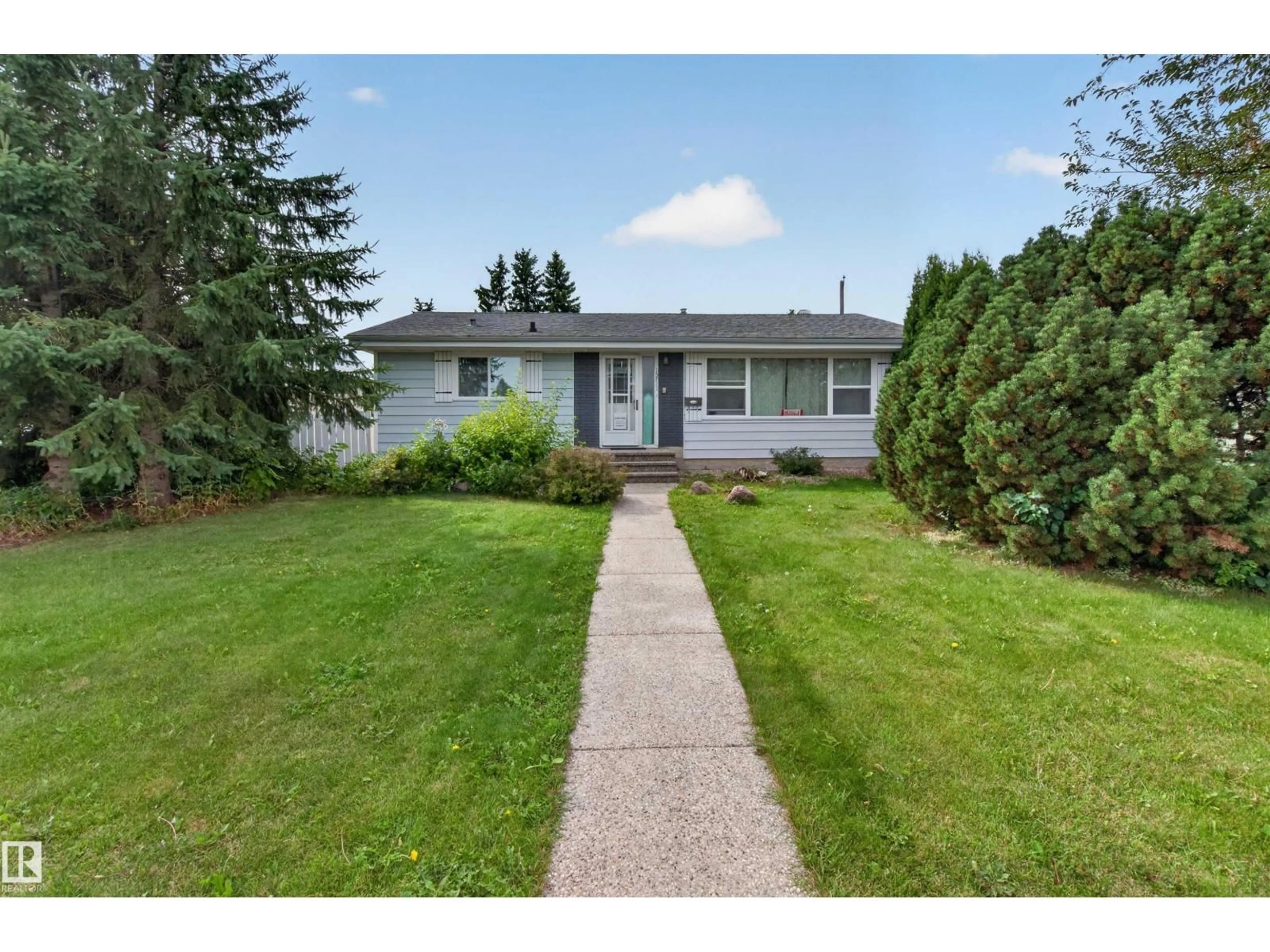 Home with vinyl exterior material, street for 15711 84 AV, Edmonton Alberta T5R3Y2