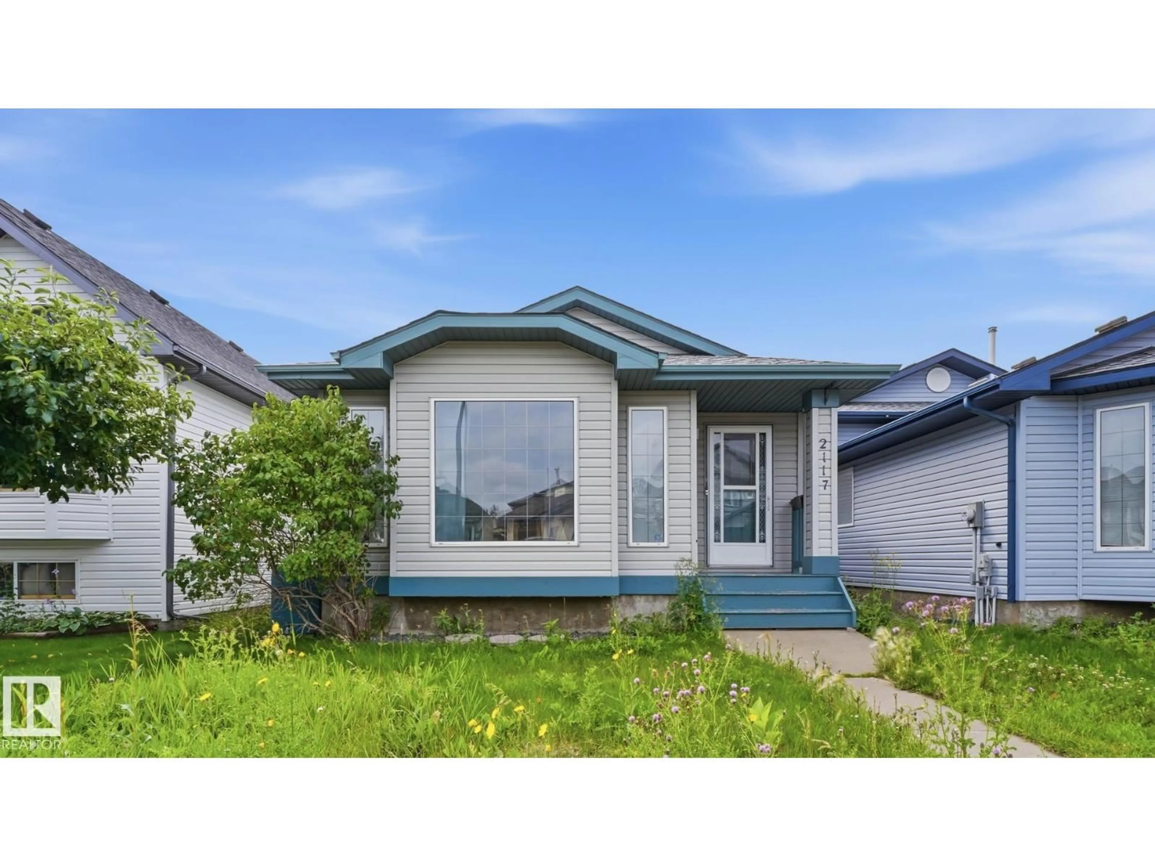 Home with vinyl exterior material, street for 2117 36 AV, Edmonton Alberta T6T1S3