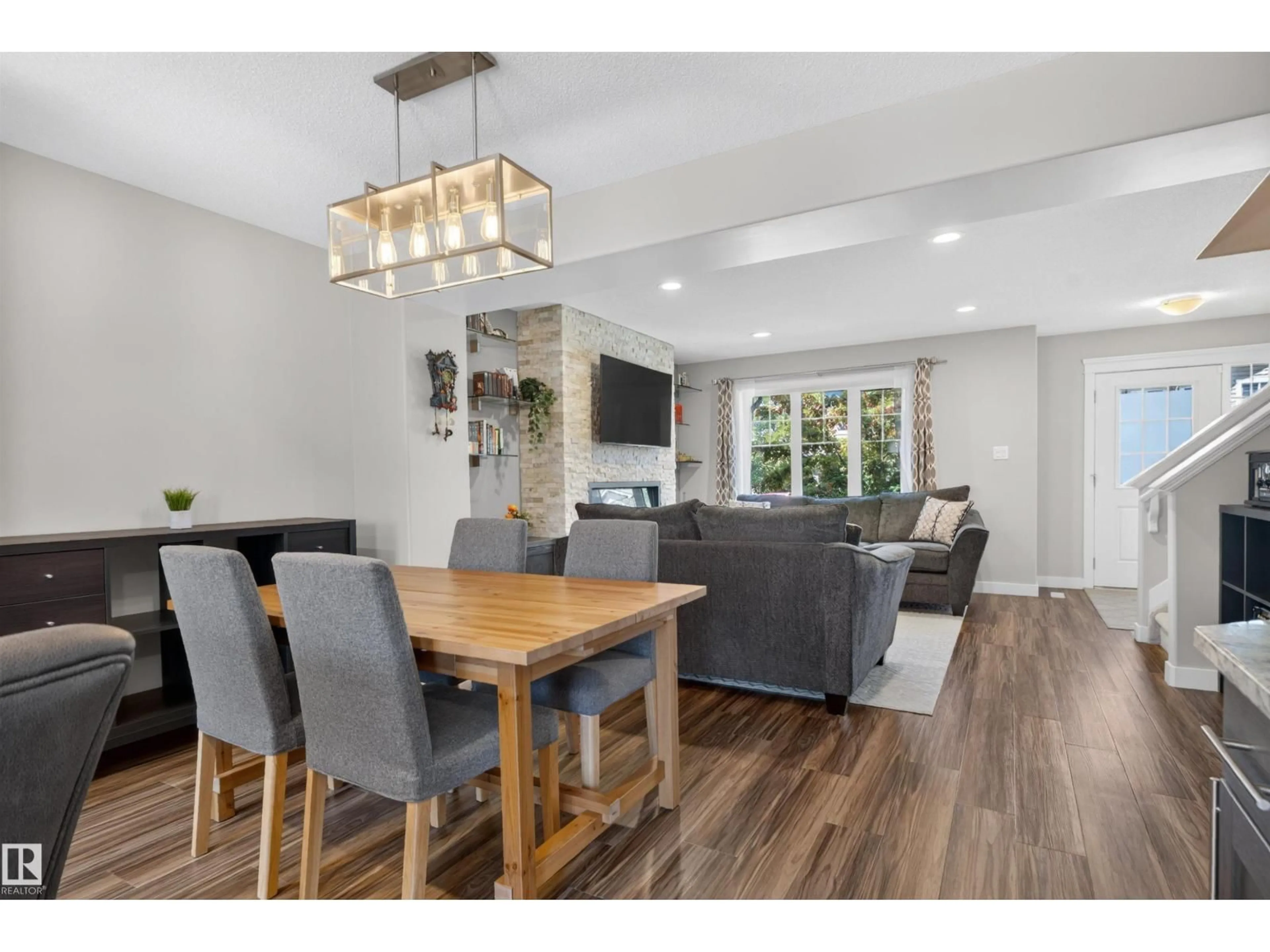 Open concept kitchen, wood/laminate floor for 319 DESROCHERS BV, Edmonton Alberta T6W3J1
