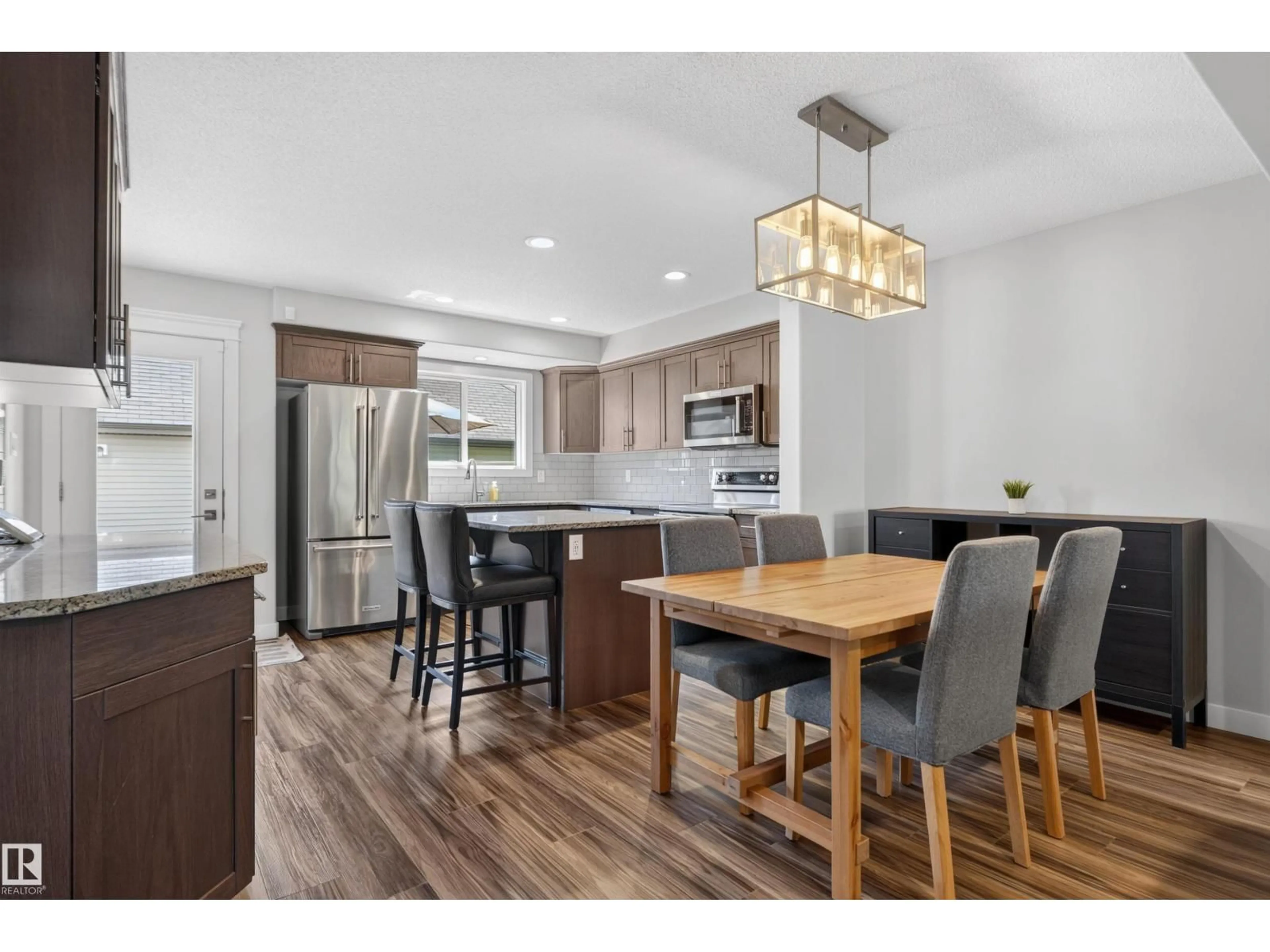 Open concept kitchen, wood/laminate floor for 319 DESROCHERS BV, Edmonton Alberta T6W3J1