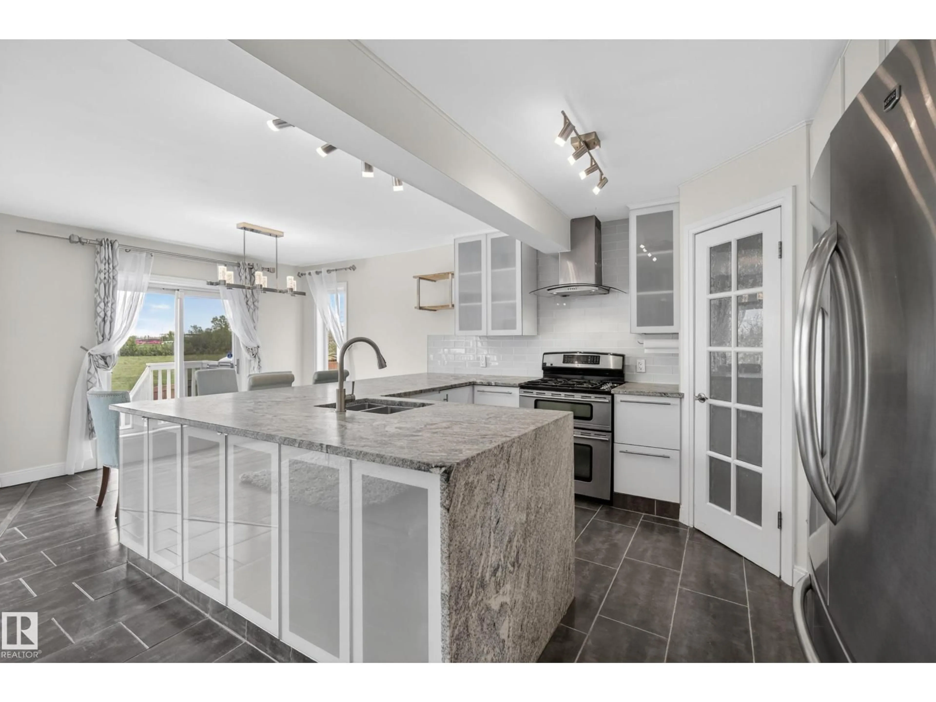 Open concept kitchen, ceramic/tile floor for 11827 8 AV, Edmonton Alberta T6J6Z9