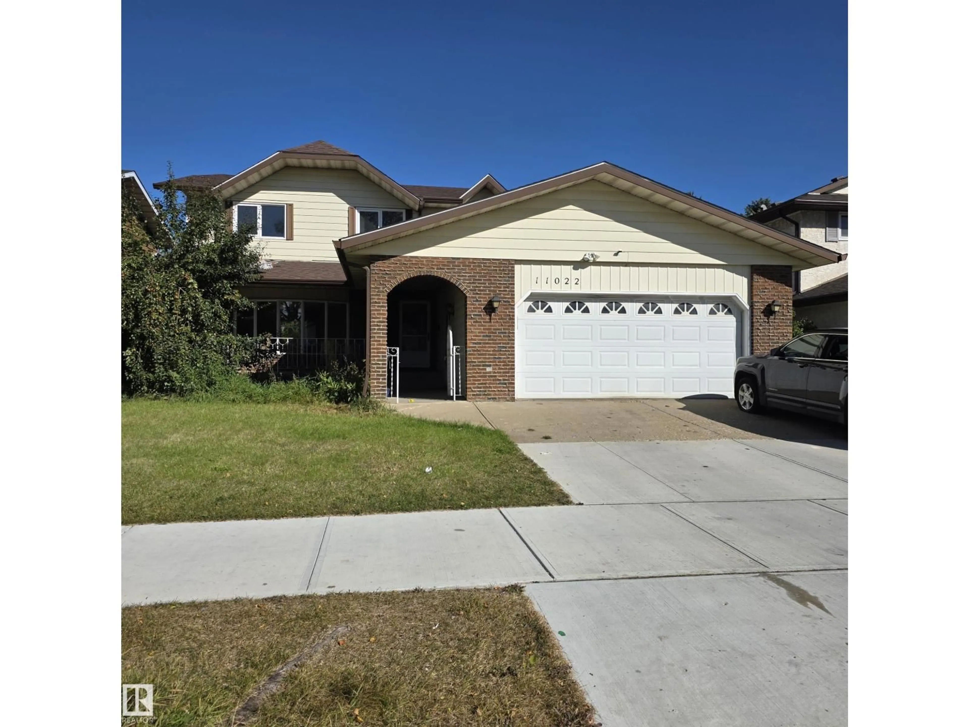 Home with vinyl exterior material, street for 11022 158 AV, Edmonton Alberta T5X4V4