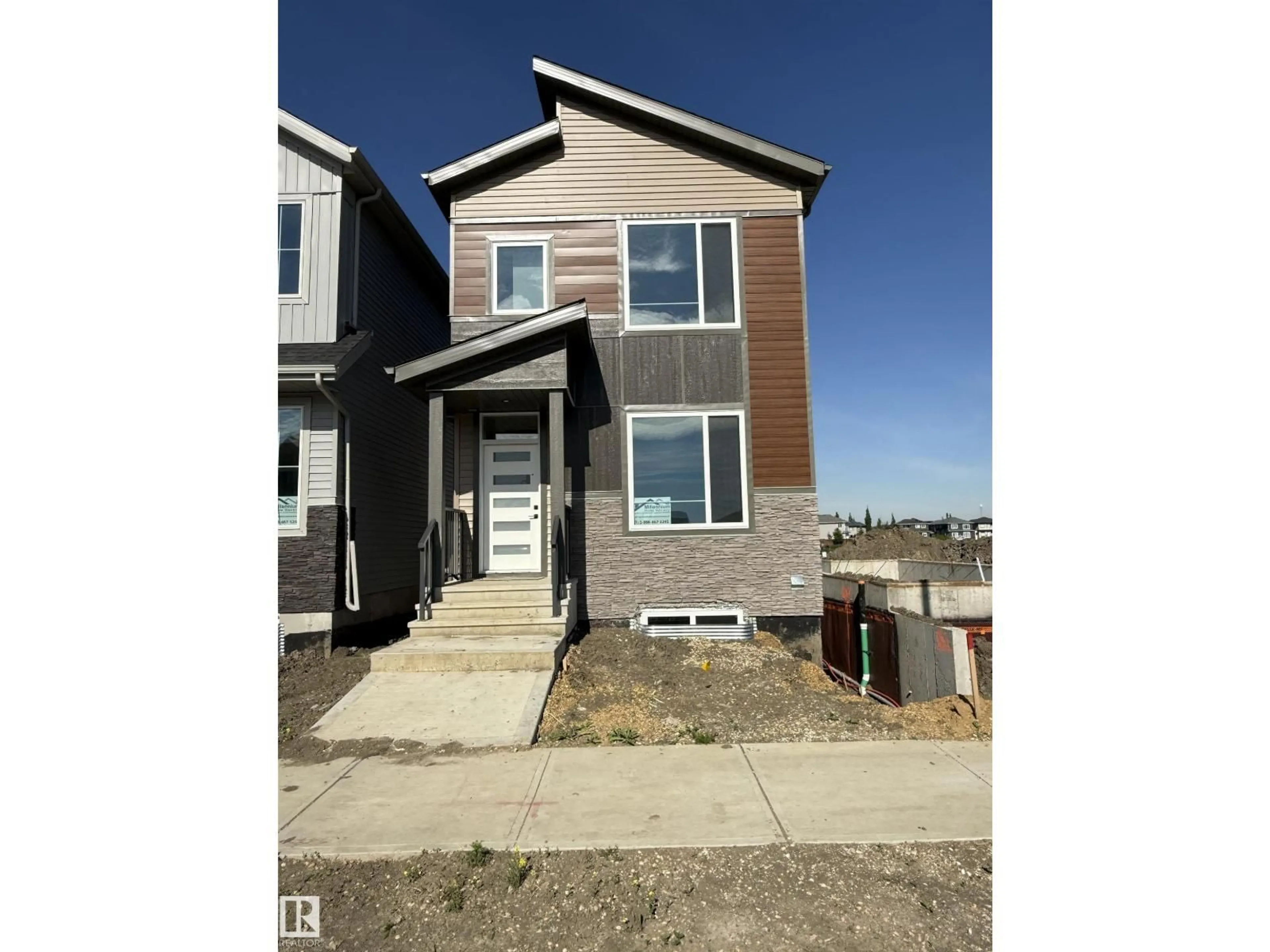 Home with vinyl exterior material, street for 102 ELLIOTT WD, Fort Saskatchewan Alberta T8L1R8