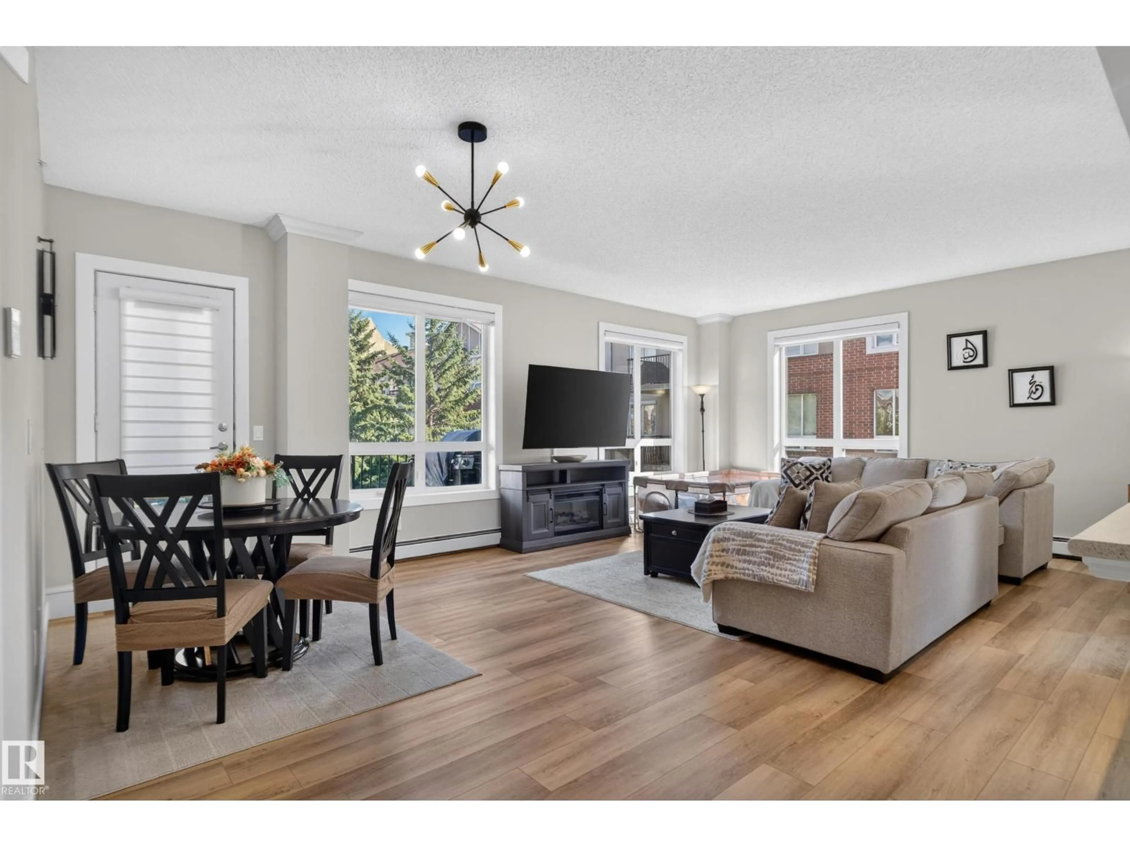 Living room with furniture, wood/laminate floor for #227 - 6315 135 AV, Edmonton Alberta T5A5J7