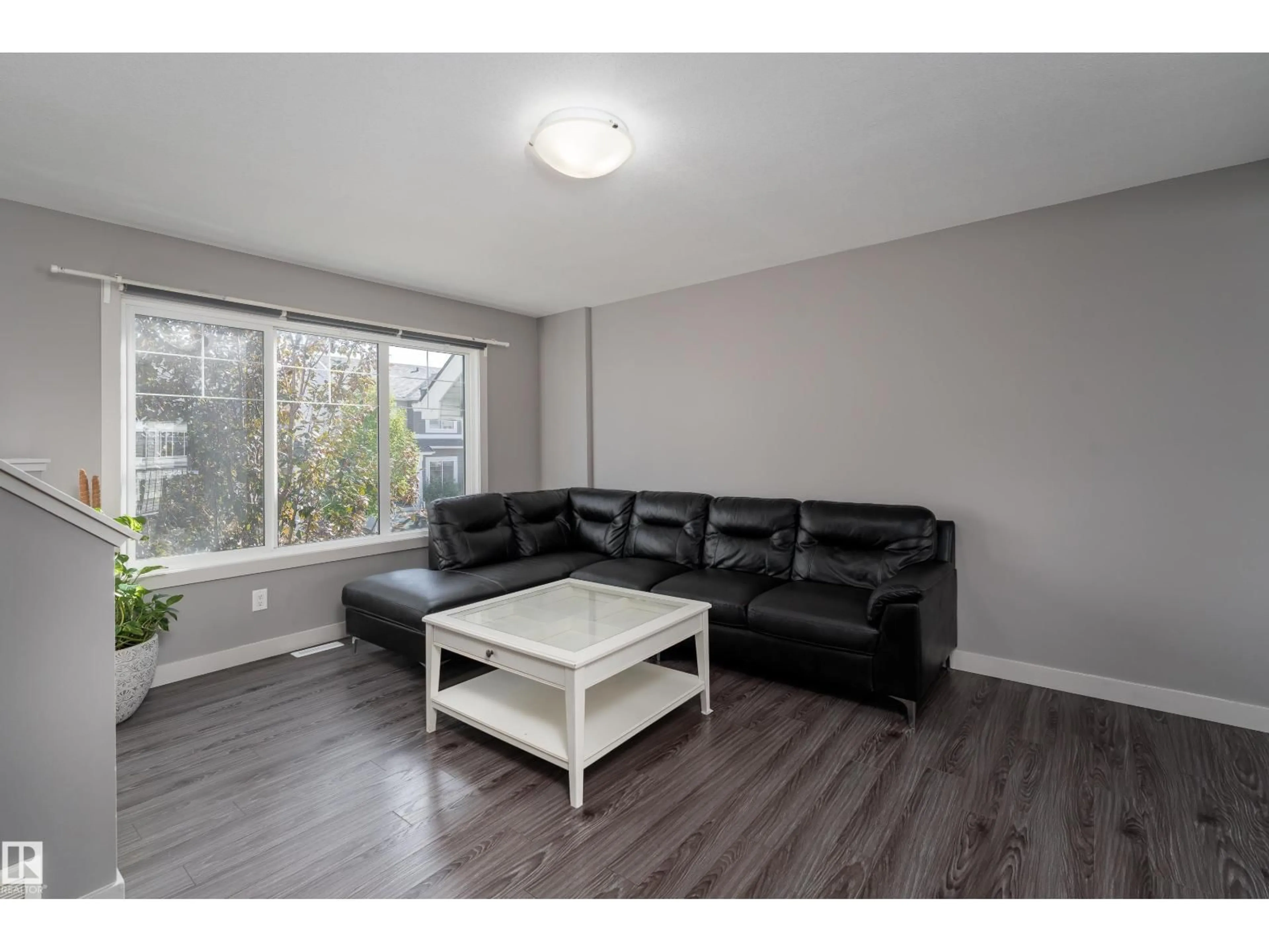 Living room with furniture, wood/laminate floor for 4205 30 ST, Edmonton Alberta T6T2G9