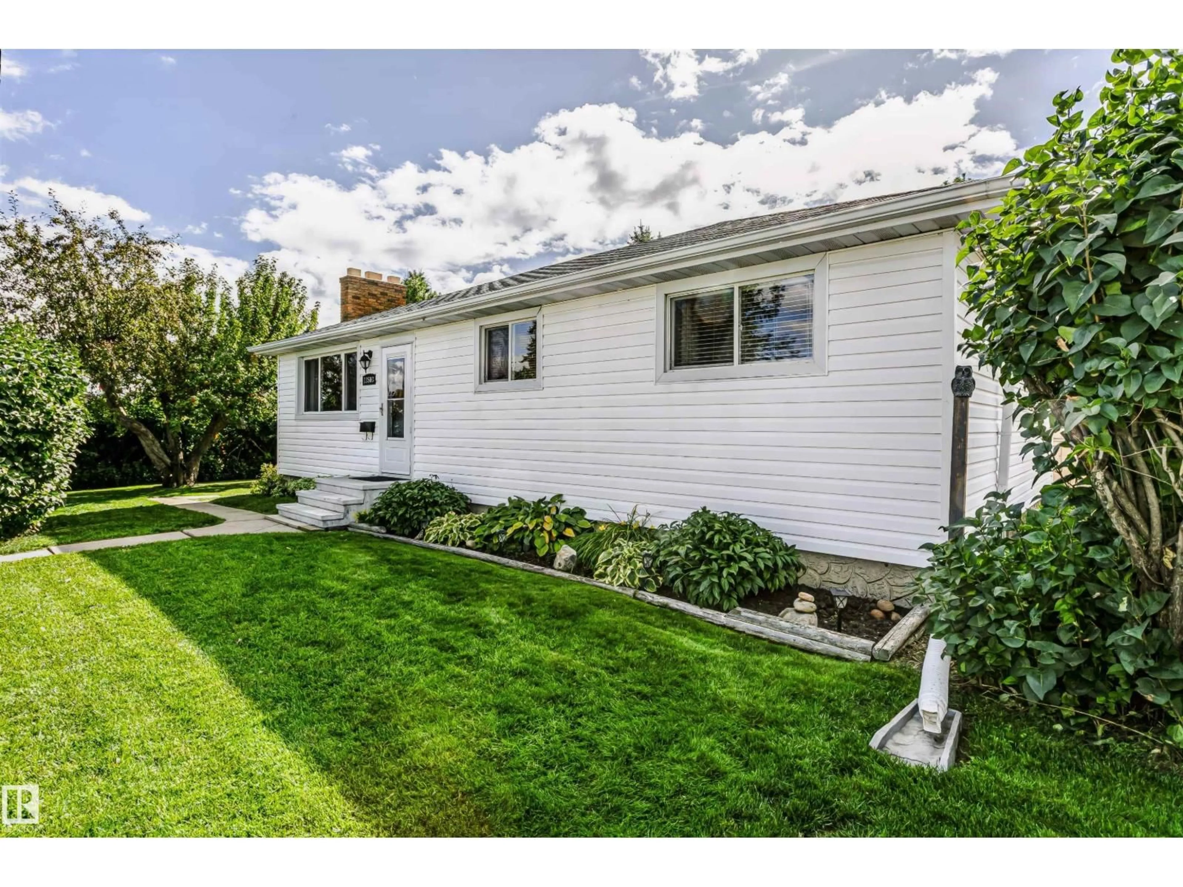 Home with vinyl exterior material, street for 13503 135 AV, Edmonton Alberta T5L3Y4