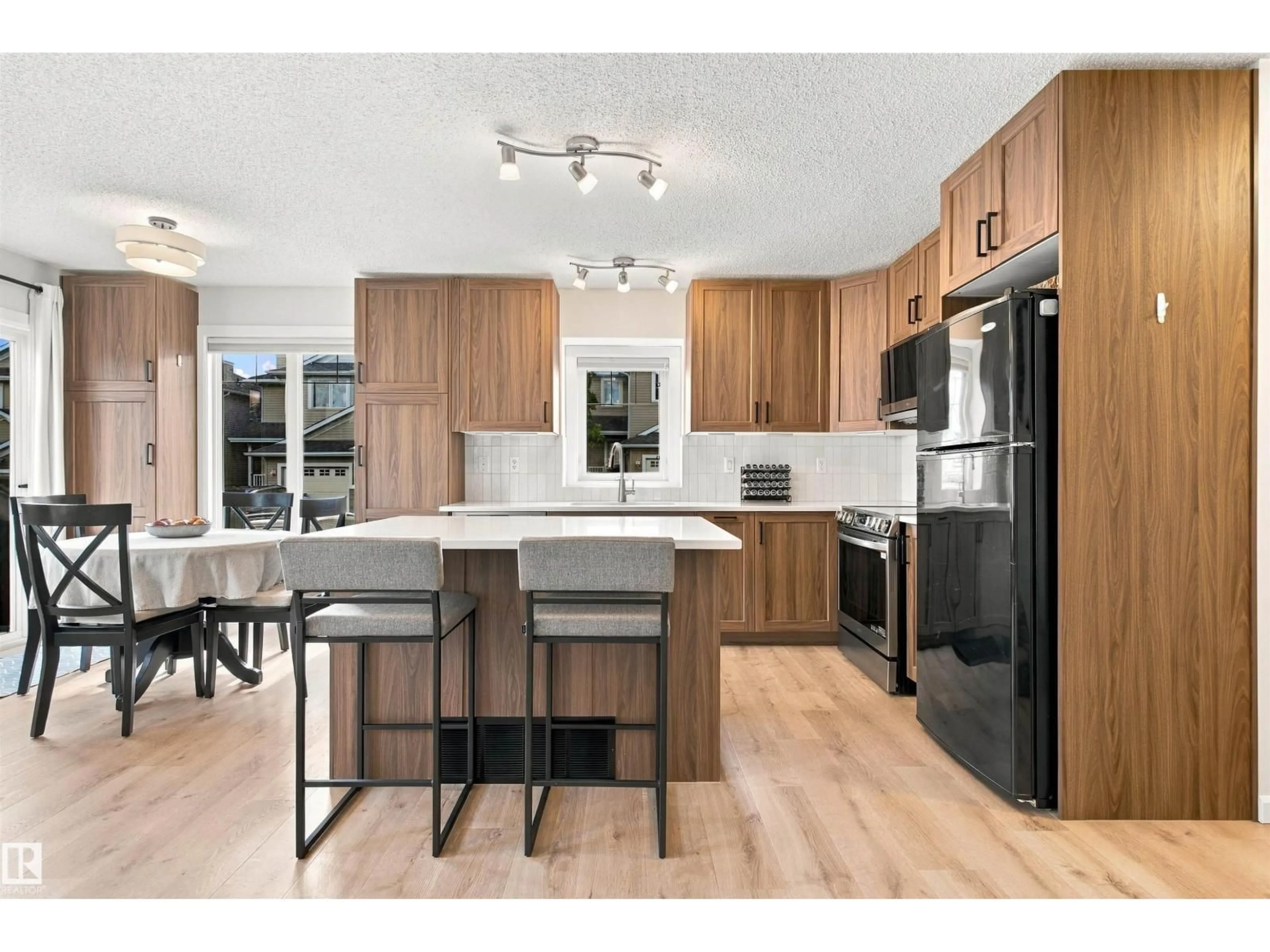 Open concept kitchen, wood/laminate floor for 120 - 60 MAGRATH RD, Edmonton Alberta T6R0C6