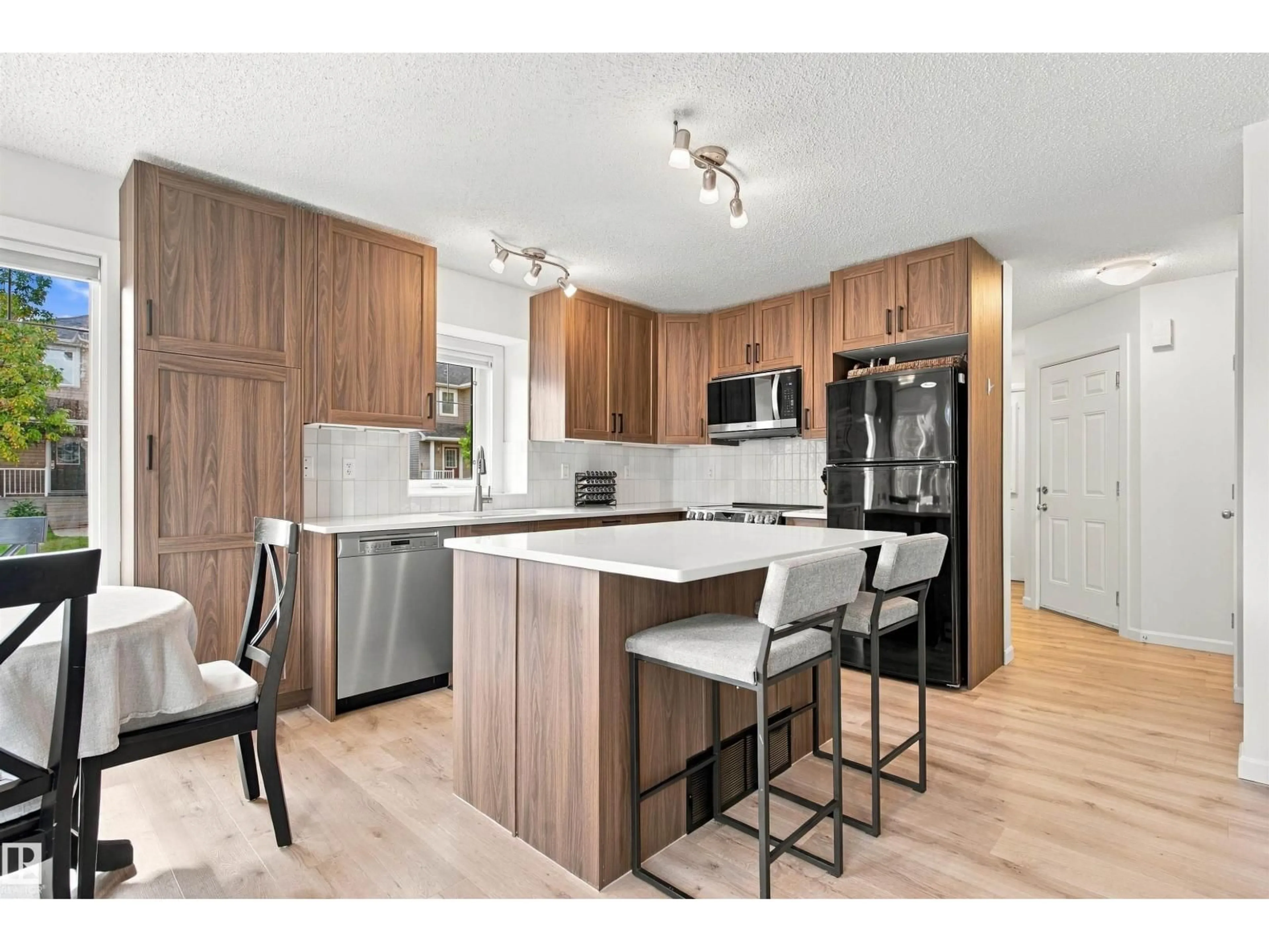 Open concept kitchen, wood/laminate floor for 120 - 60 MAGRATH RD, Edmonton Alberta T6R0C6