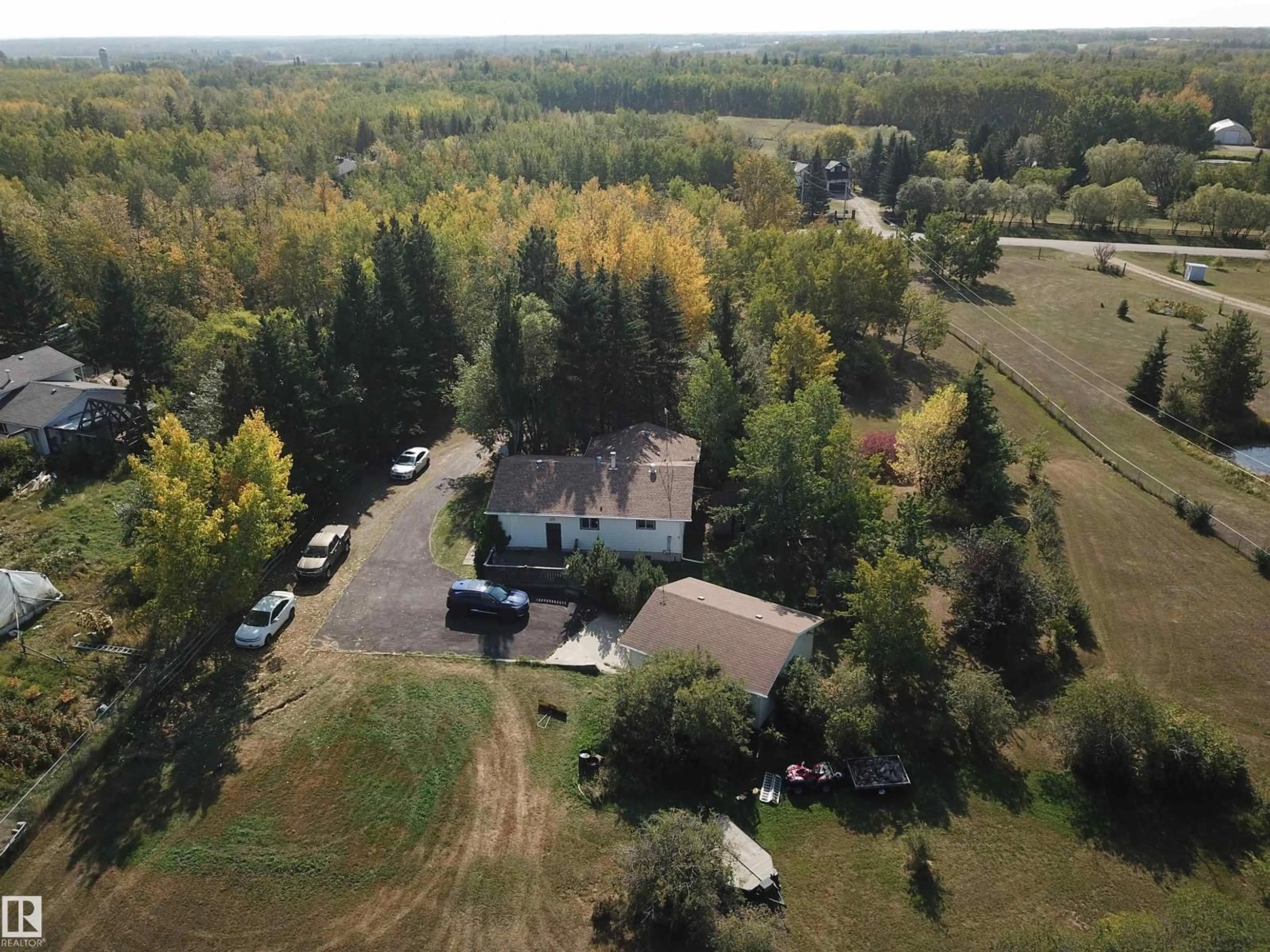 A pic from outside/outdoor area/front of a property/back of a property/a pic from drone, forest/trees view for 390 50448 RG RD RD, Rural Leduc County Alberta T0B3M2