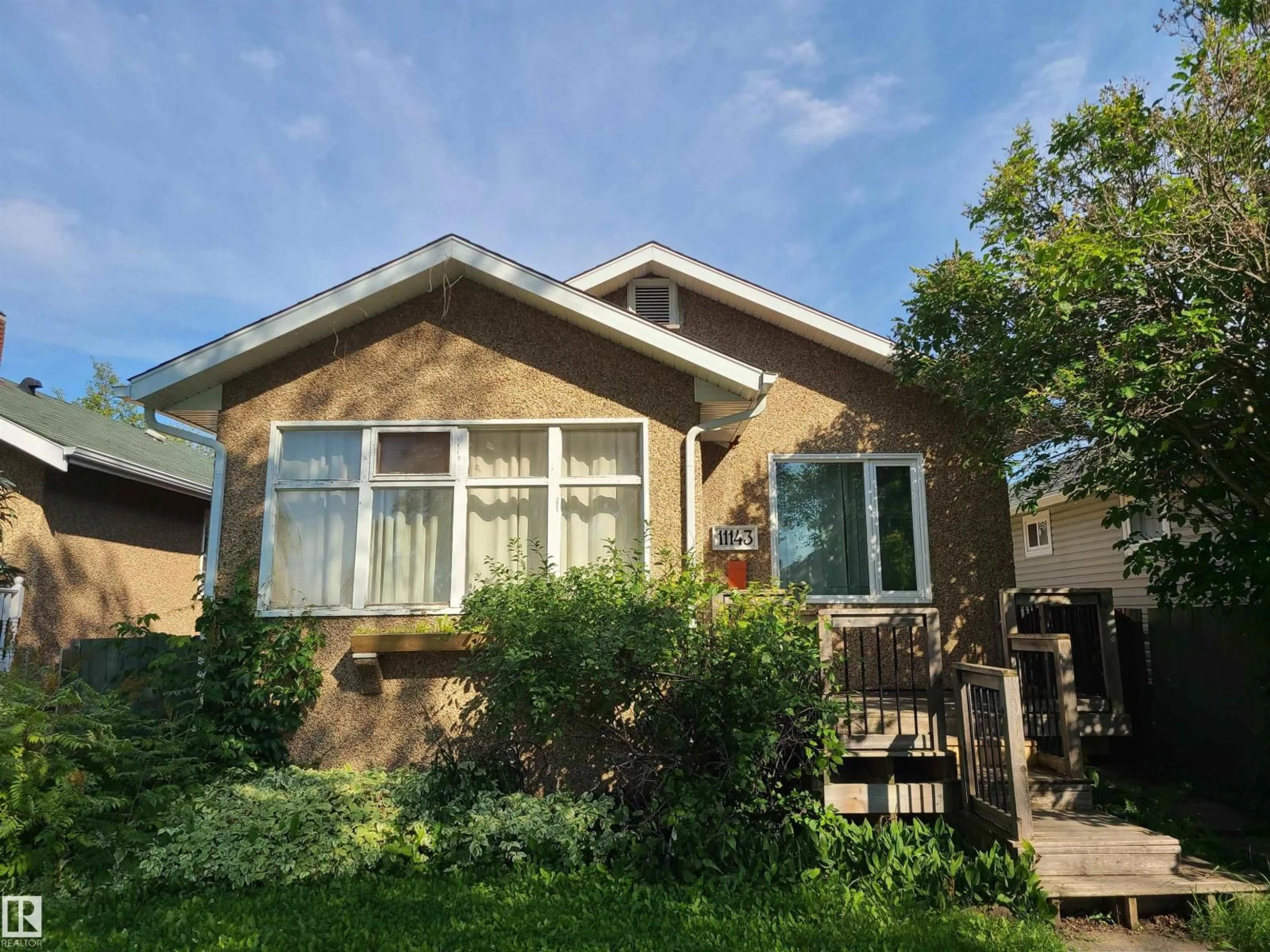 Home with vinyl exterior material, street for 11143 127 ST, Edmonton Alberta T5M0T5