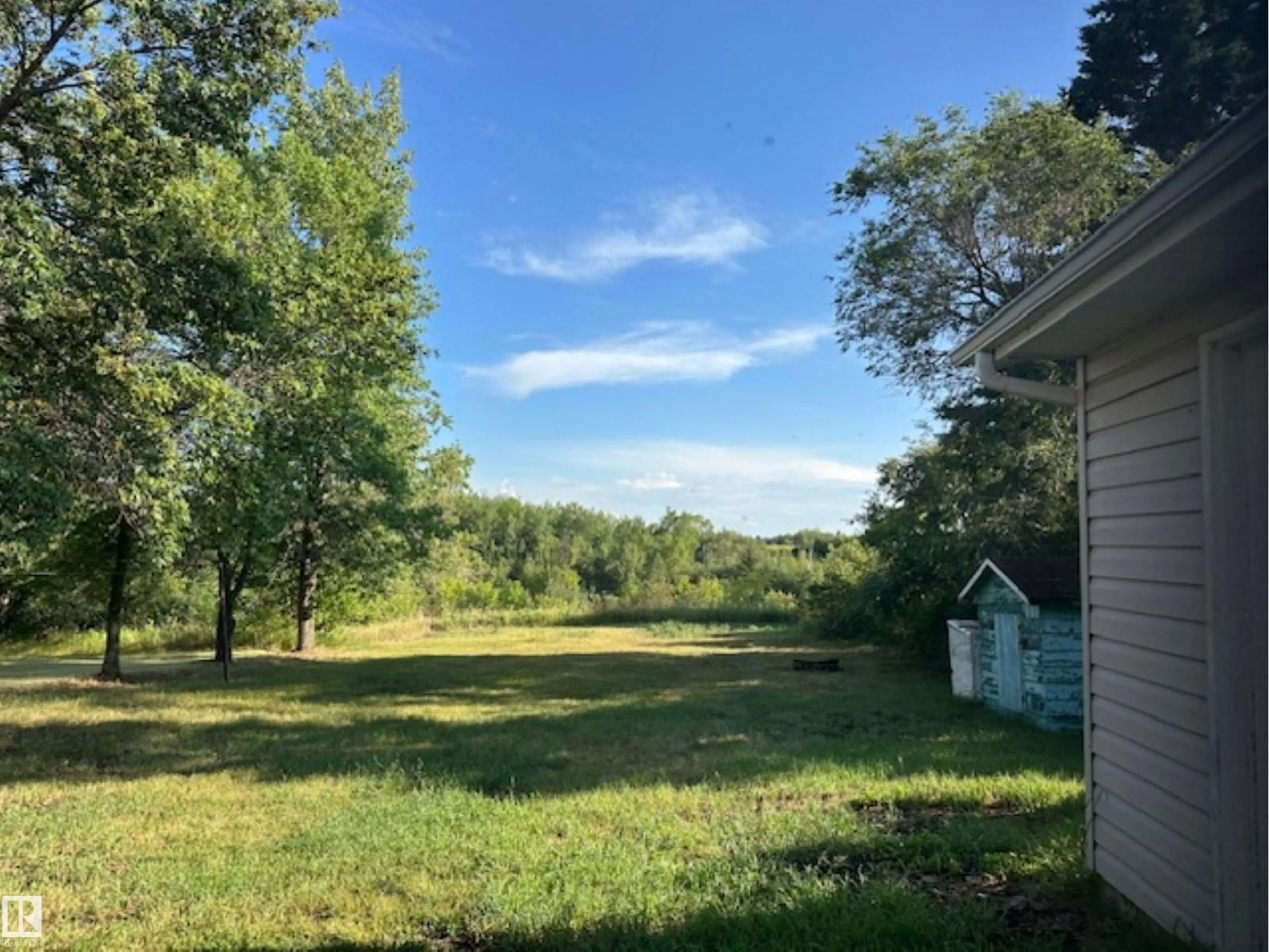 A pic from outside/outdoor area/front of a property/back of a property/a pic from drone, forest/trees view for 4711 51 AV, Waskatenau Alberta T0A3P0