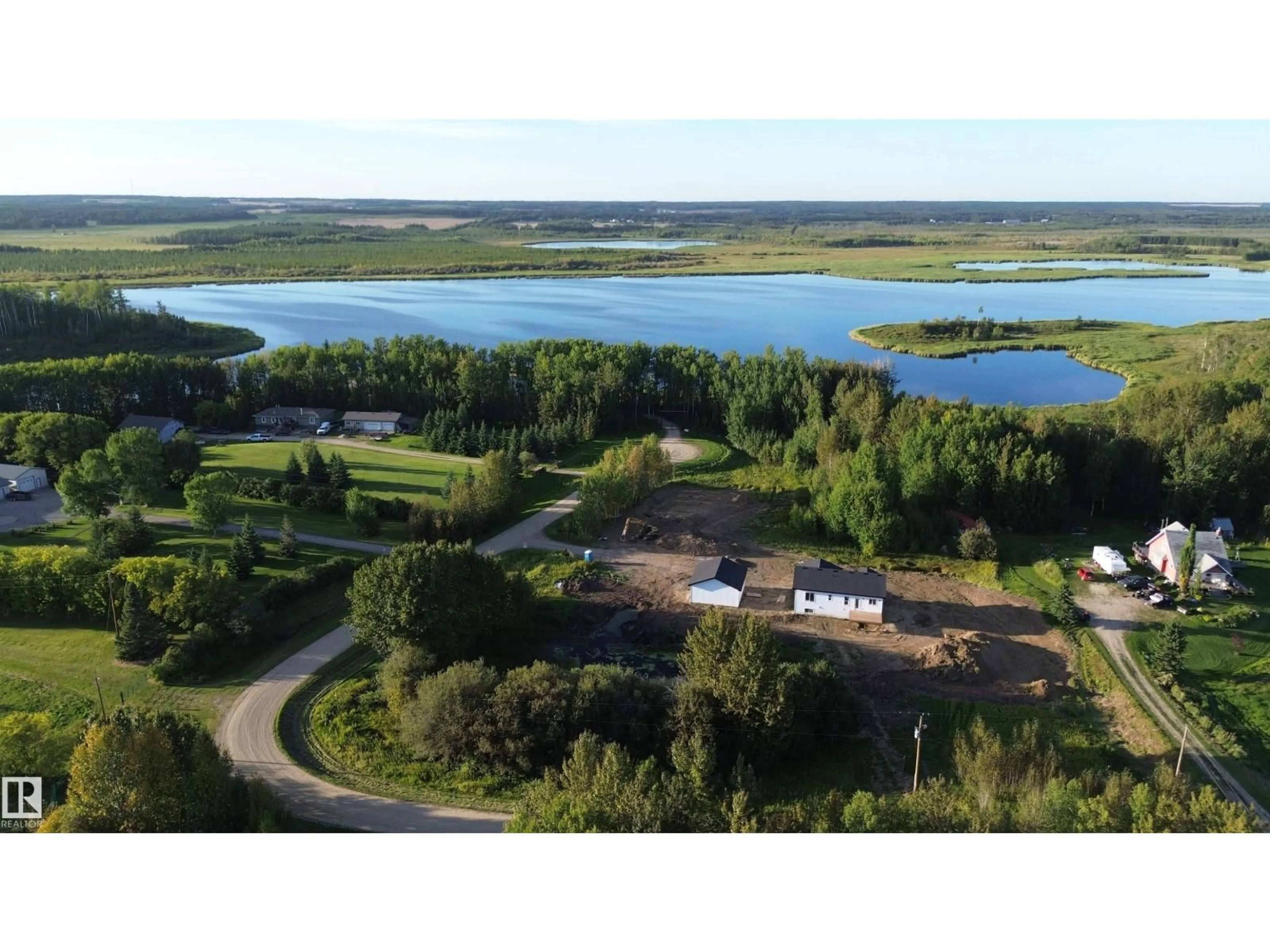 A pic from outside/outdoor area/front of a property/back of a property/a pic from drone, water/lake/river/ocean view for #14 - 52510 RGE ROAD 25, Rural Parkland County Alberta T7Y2M2