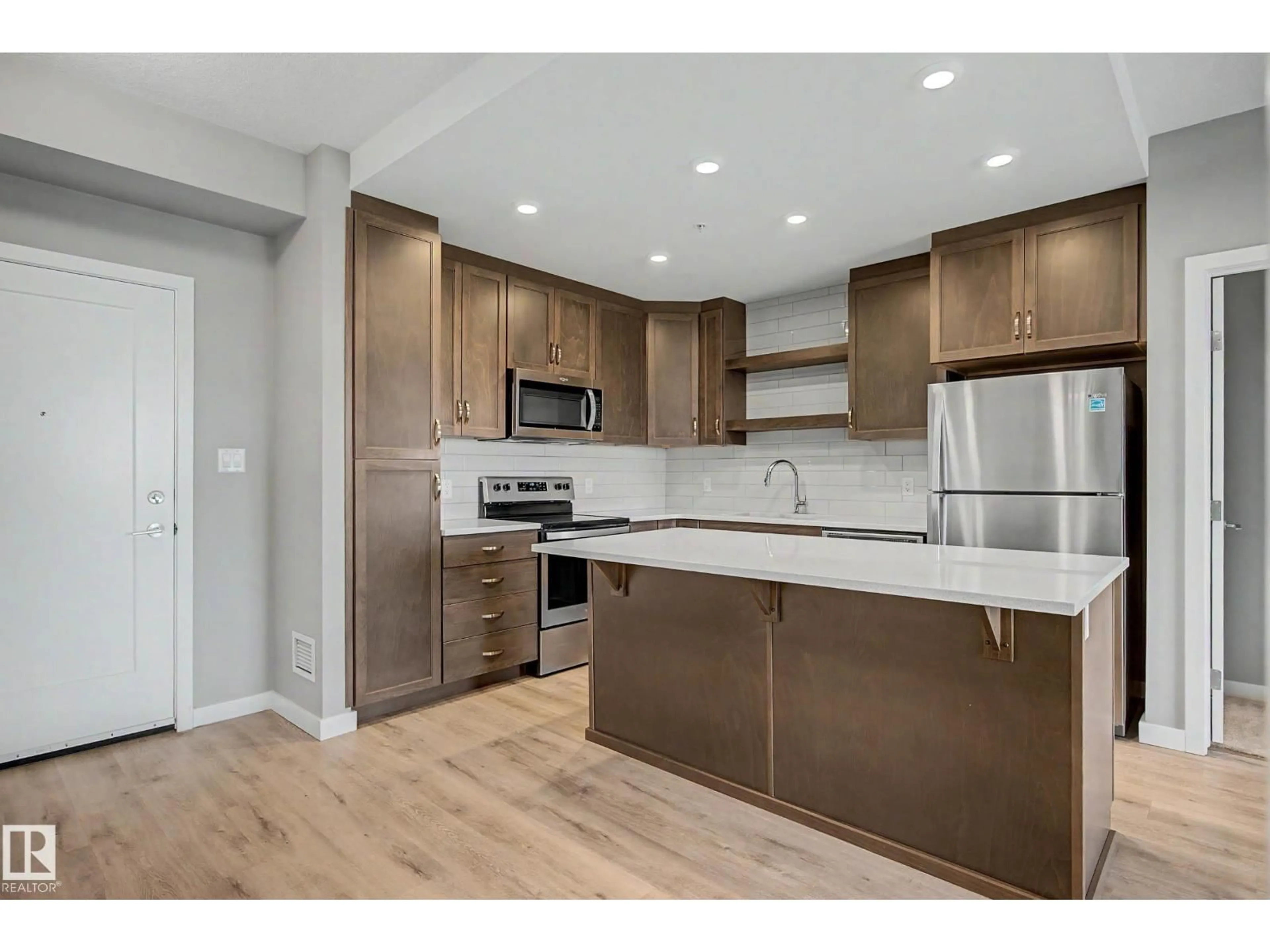 Open concept kitchen, wood/laminate floor for 437 - 5504 SCHONSEE DR, Edmonton Alberta T5Z0N9
