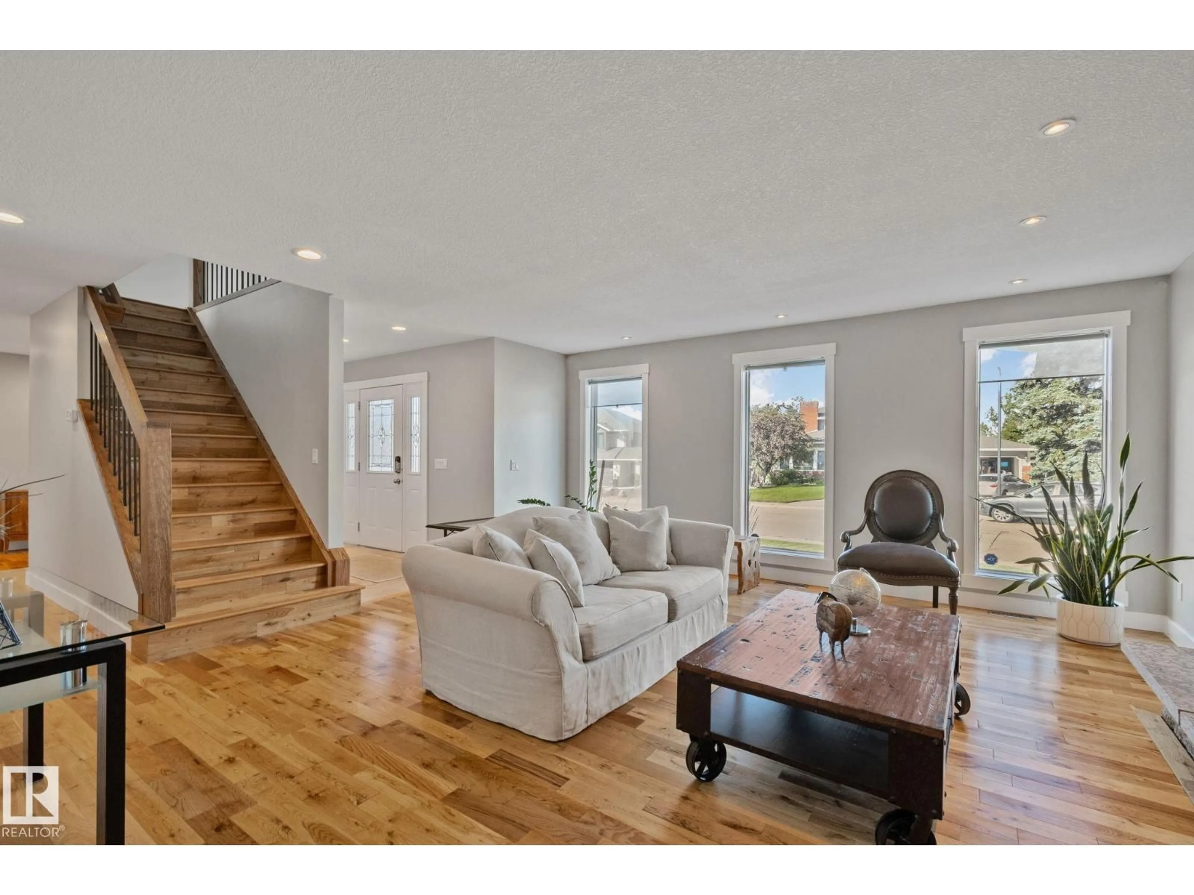 Living room with furniture, wood/laminate floor for 12403 29A AV, Edmonton Alberta T6J6C7