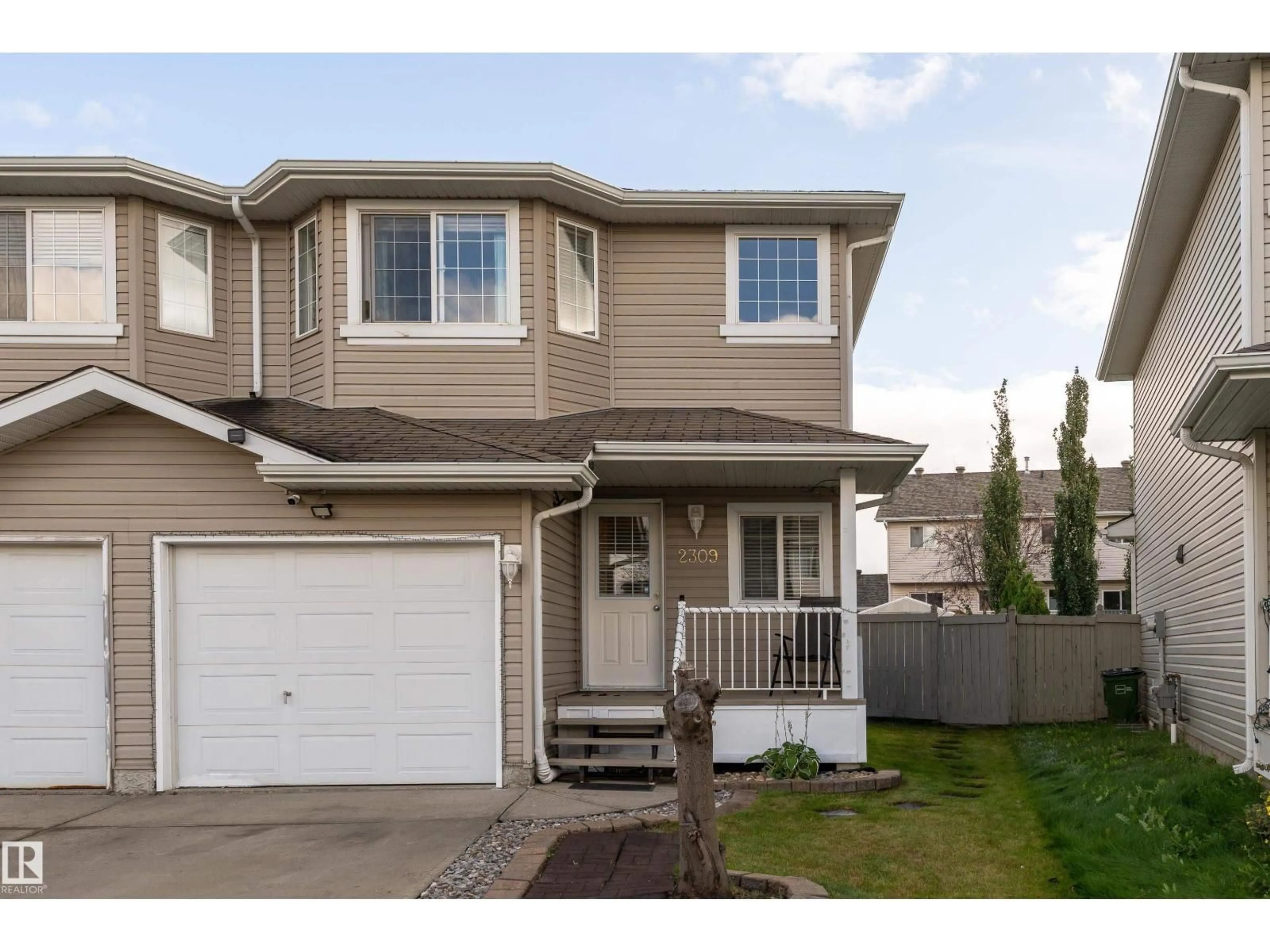 Home with vinyl exterior material, street for 2309 27 AV, Edmonton Alberta T6T0A5