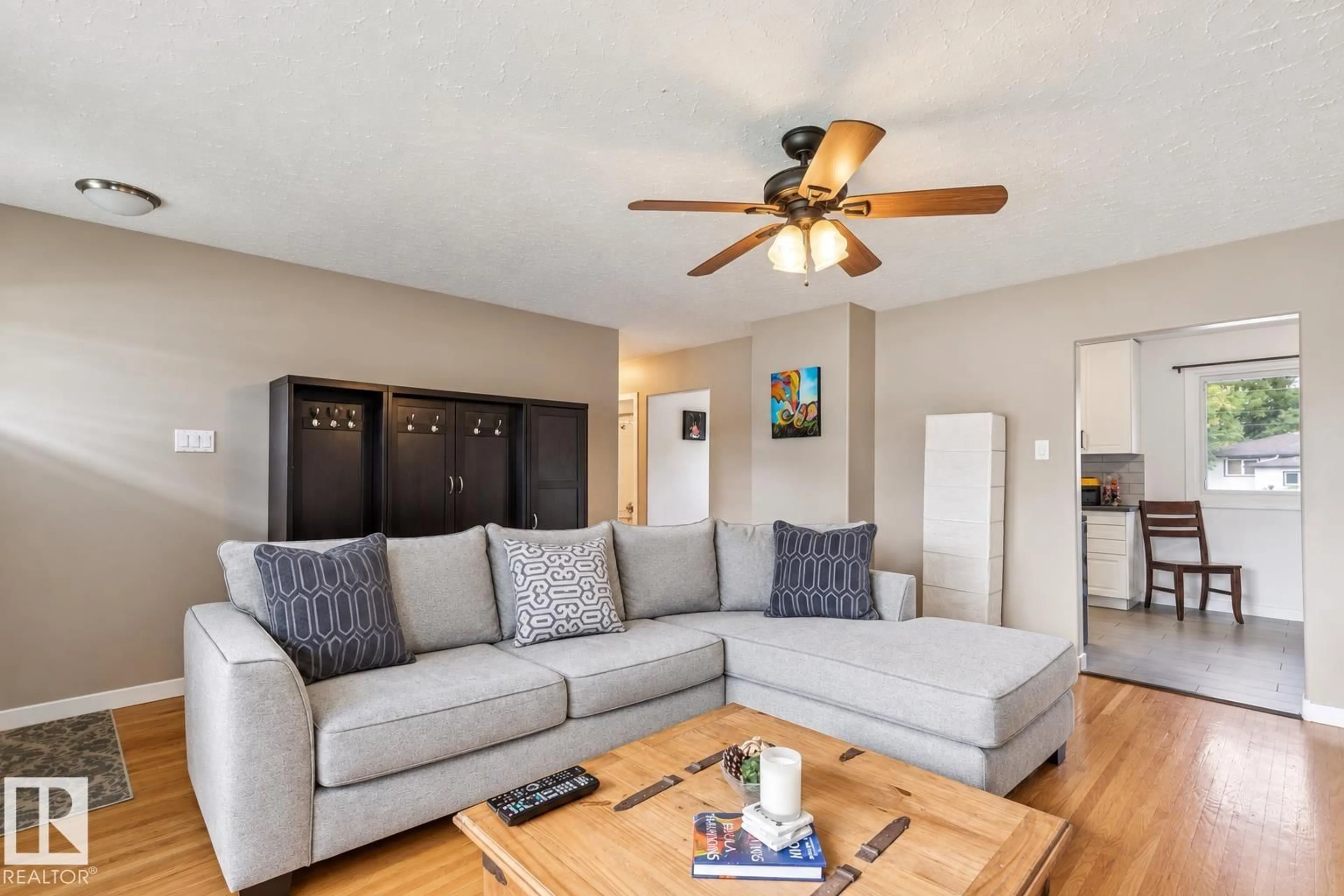 Living room with furniture, wood/laminate floor for 16522 104 AV, Edmonton Alberta T5P0S7