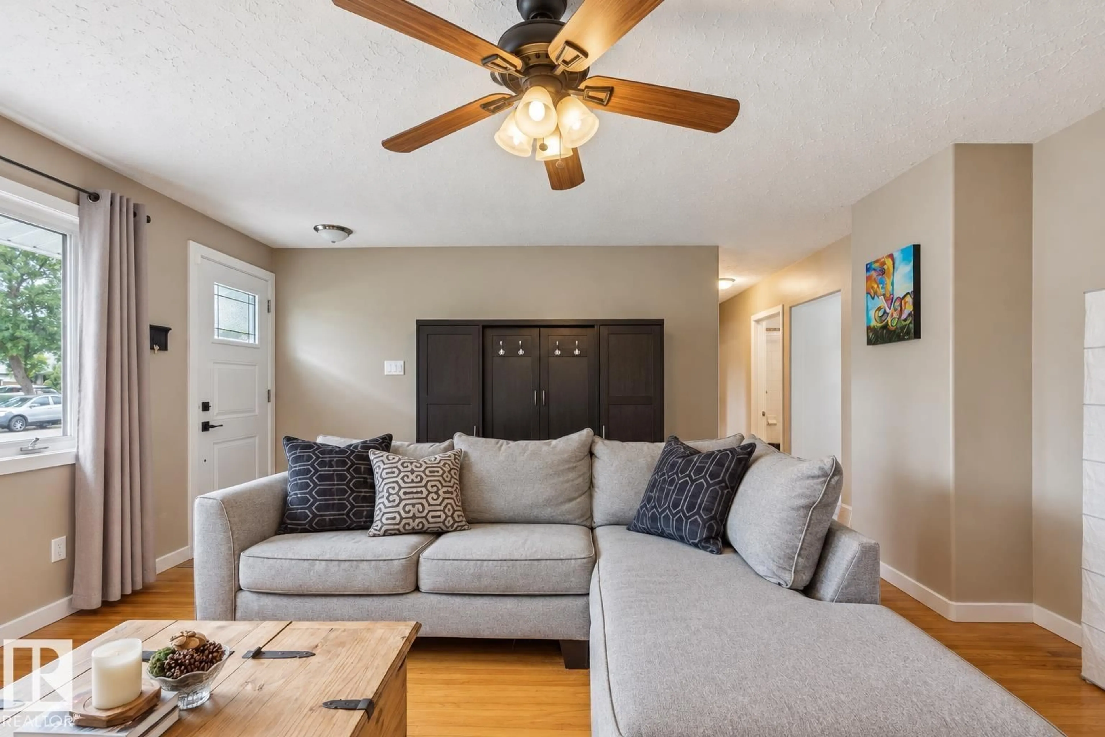 Living room with furniture, wood/laminate floor for 16522 104 AV, Edmonton Alberta T5P0S7