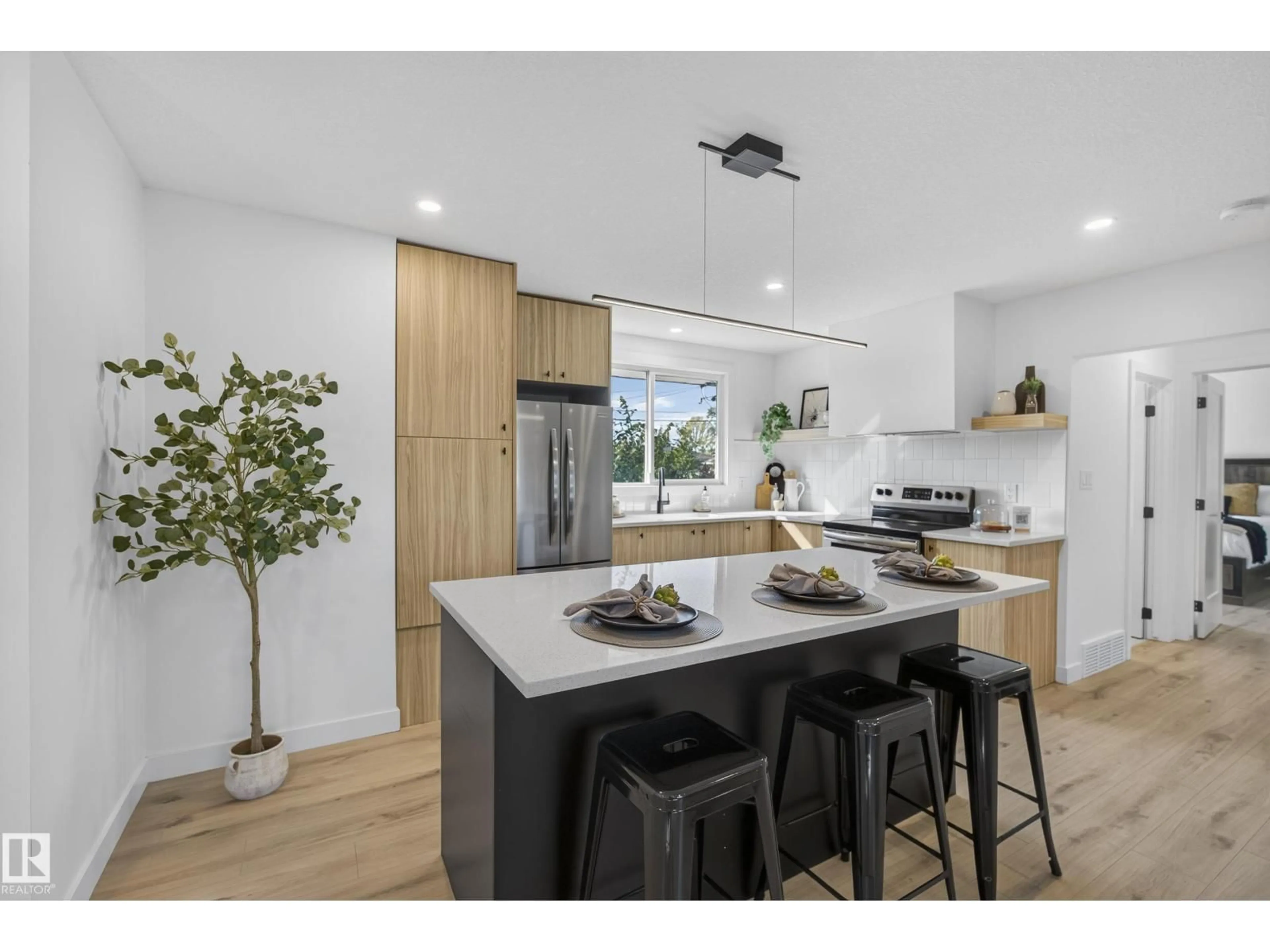 Open concept kitchen, wood/laminate floor for 11411 MALMO RD, Edmonton Alberta T6H4M3