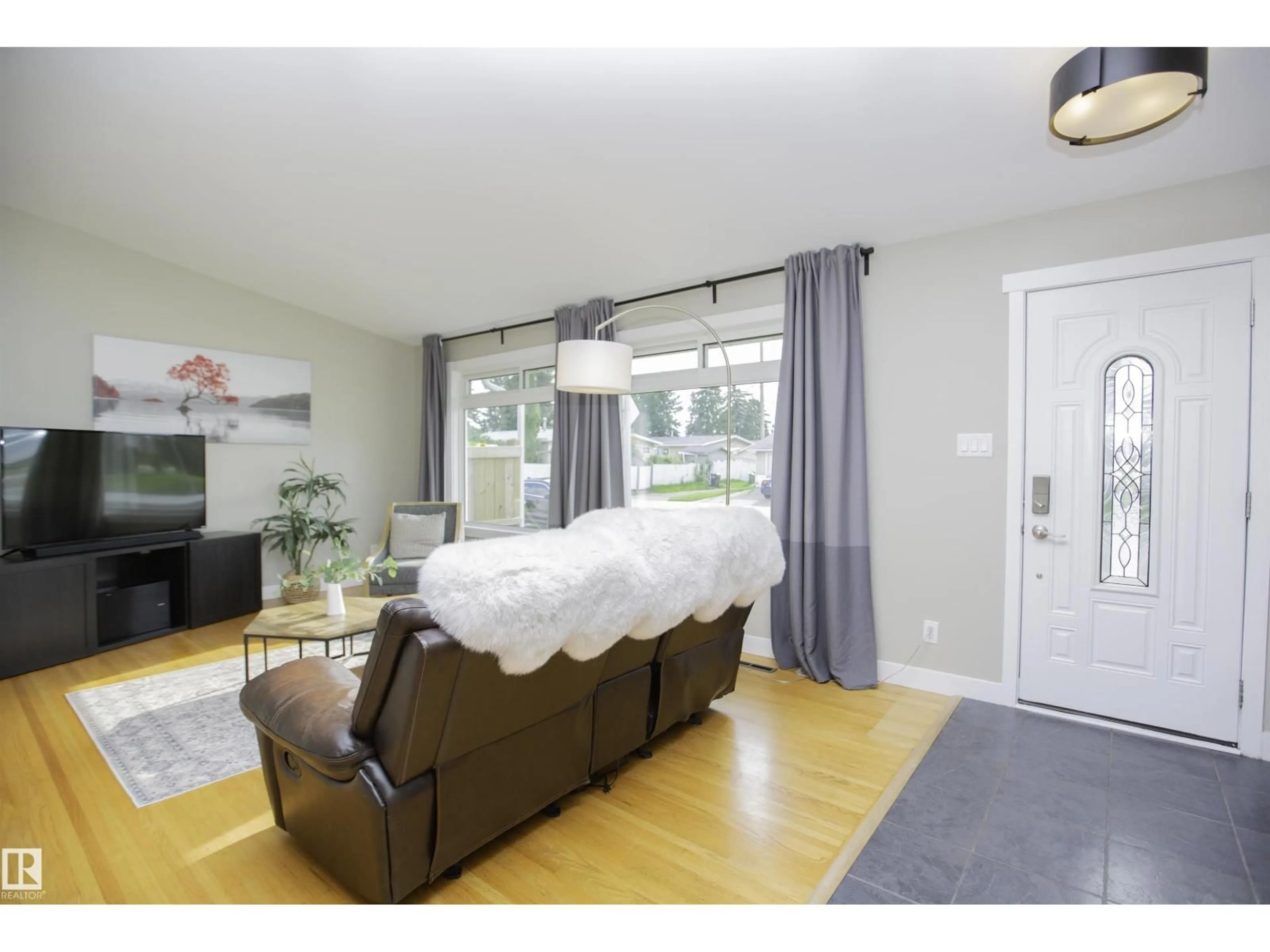 Living room with furniture, wood/laminate floor for NW - 9107 58 ST, Edmonton Alberta T6B1L3
