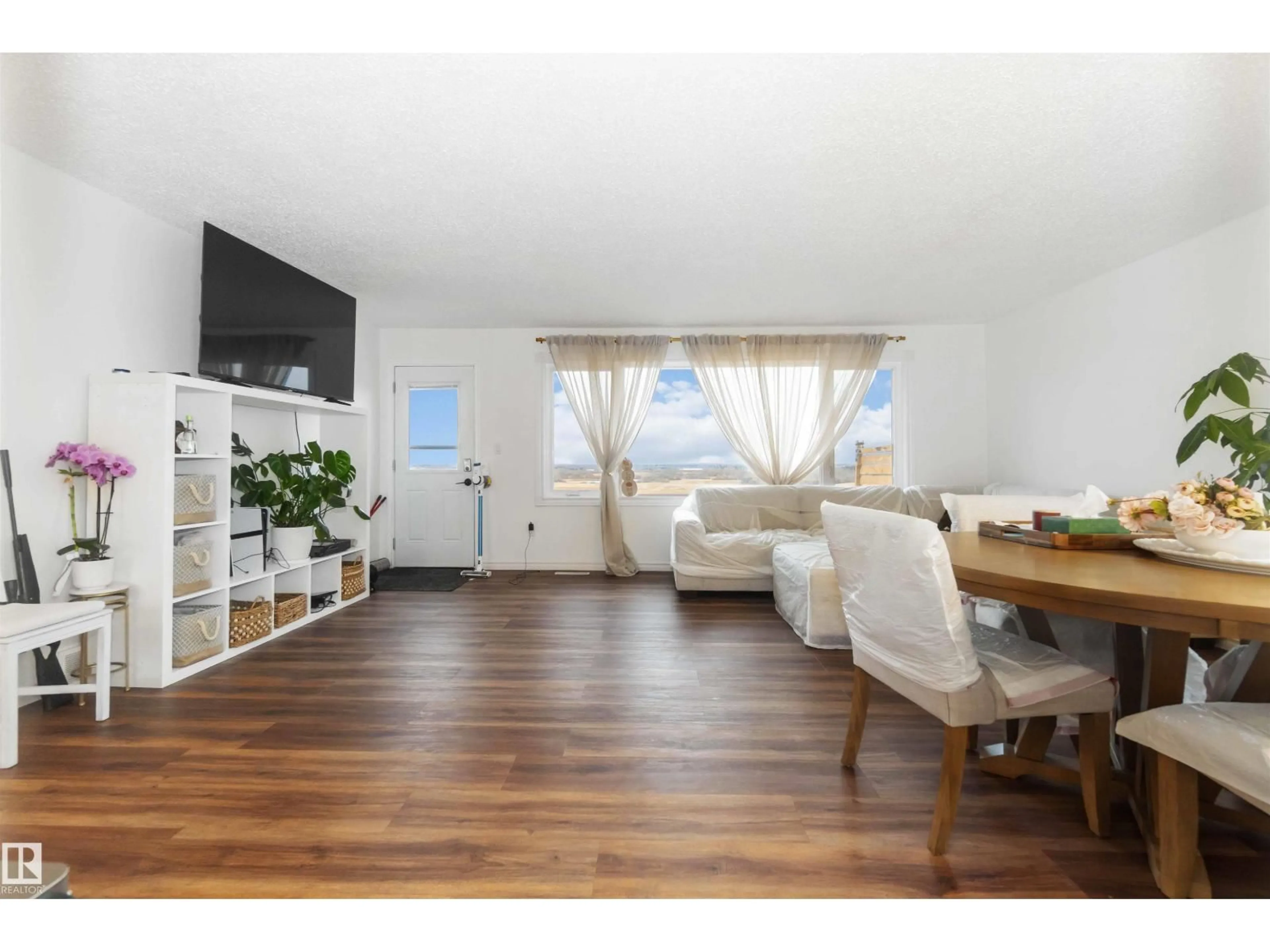 Living room with furniture, wood/laminate floor for 53273 RGE ROAD 215, Rural Strathcona County Alberta T8E2B4