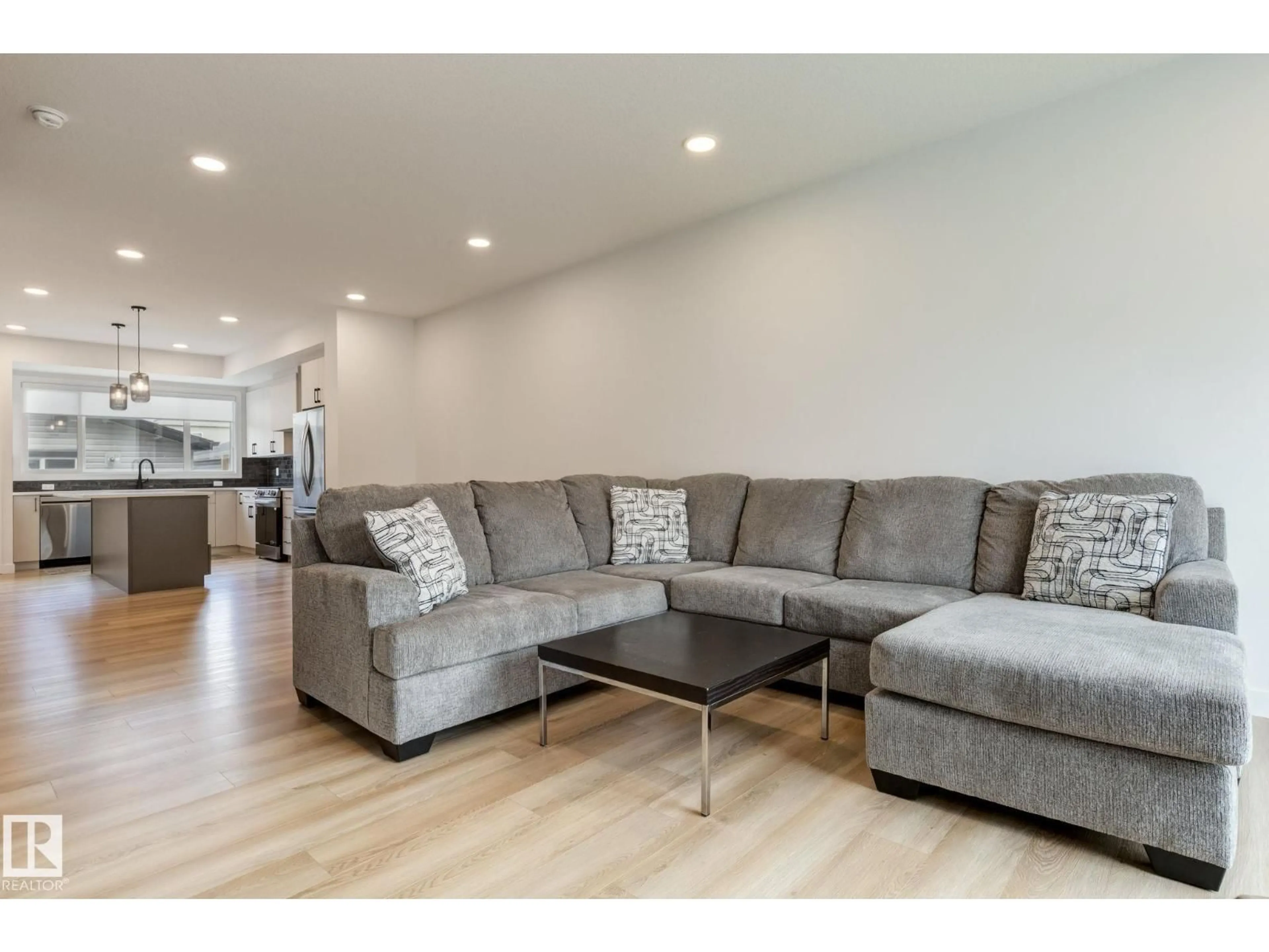 Living room with furniture, wood/laminate floor for 202 STARLING WAY, Fort Saskatchewan Alberta T8L0X9