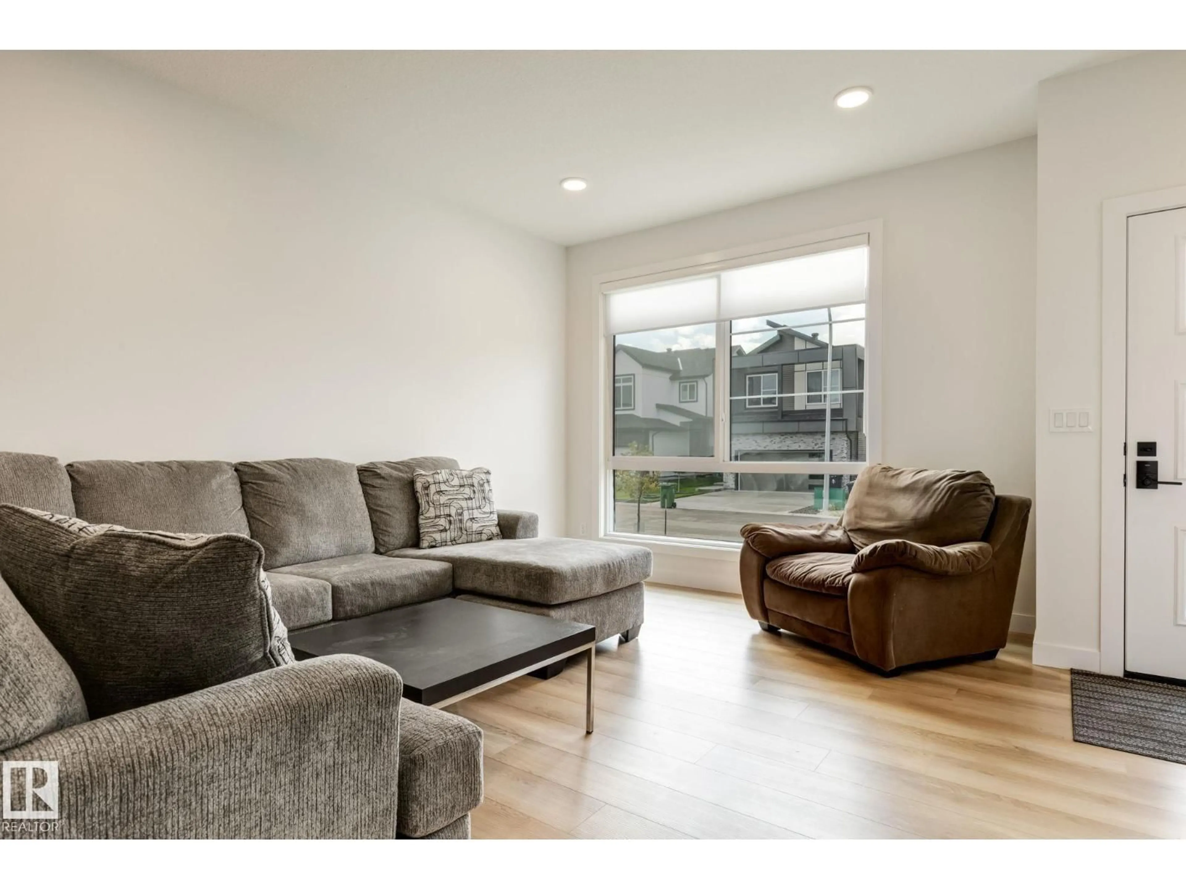 Living room with furniture, wood/laminate floor for 202 STARLING WAY, Fort Saskatchewan Alberta T8L0X9