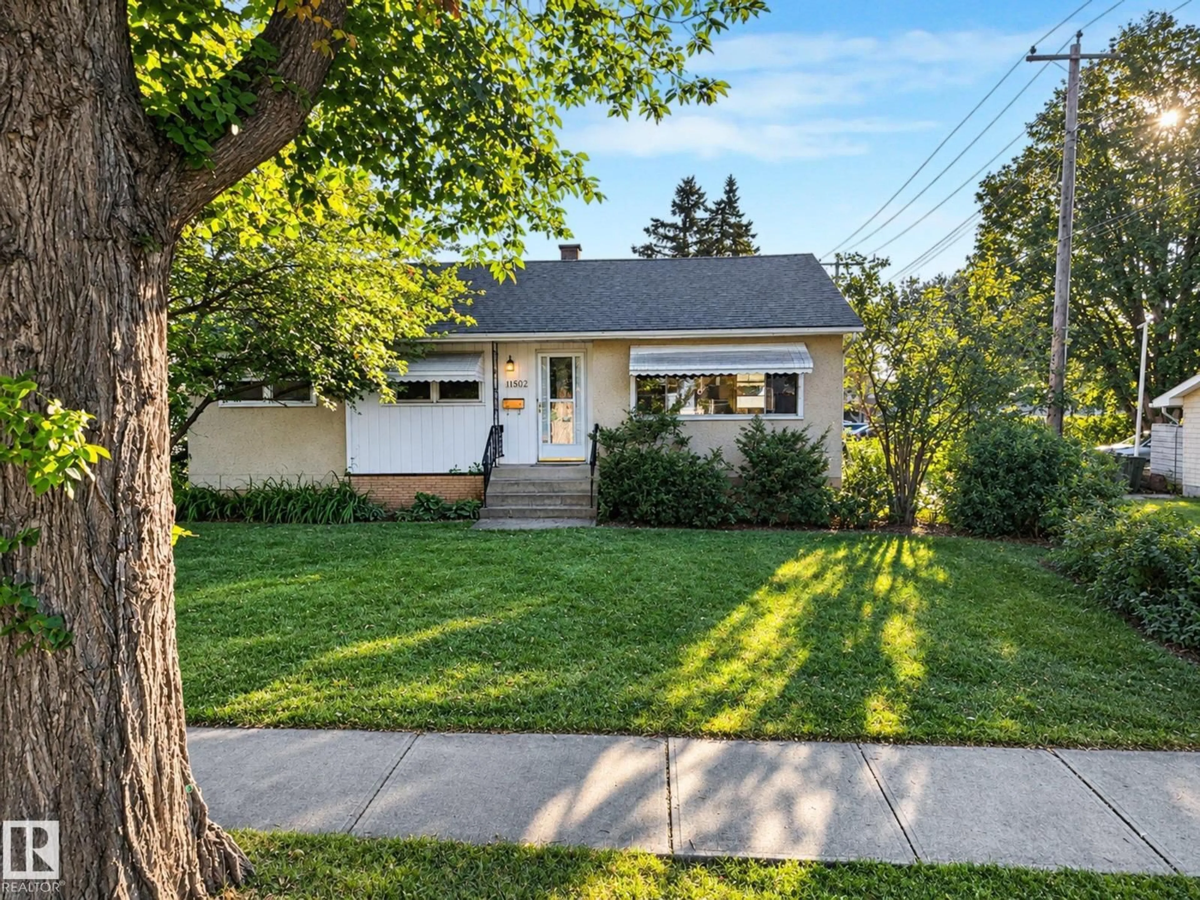 Home with vinyl exterior material, street for NW - 11507 135 ST, Edmonton Alberta T5M1K9