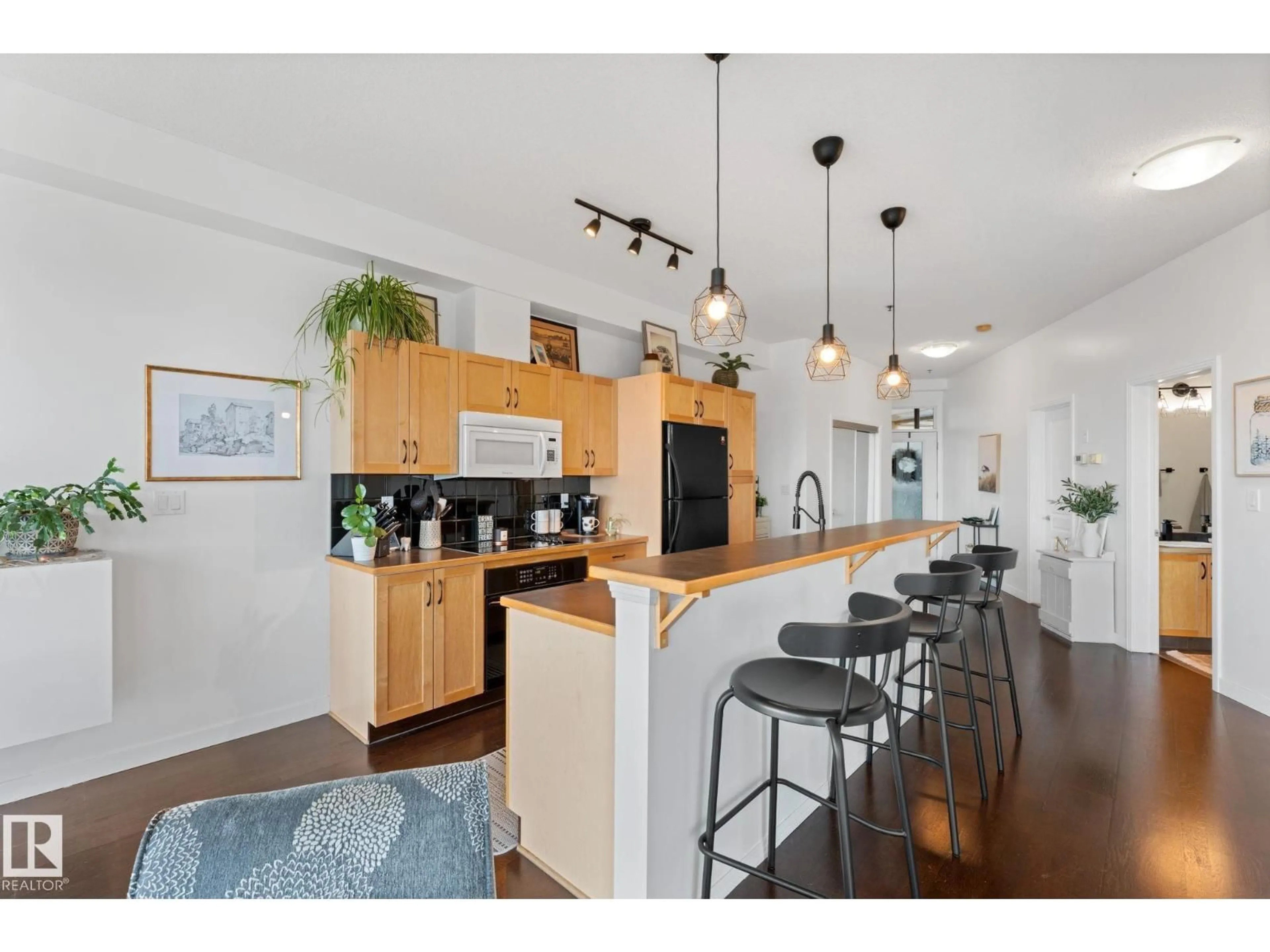 Open concept kitchen, wood/laminate floor for #408 - 4835 104A ST, Edmonton Alberta T6H0R5