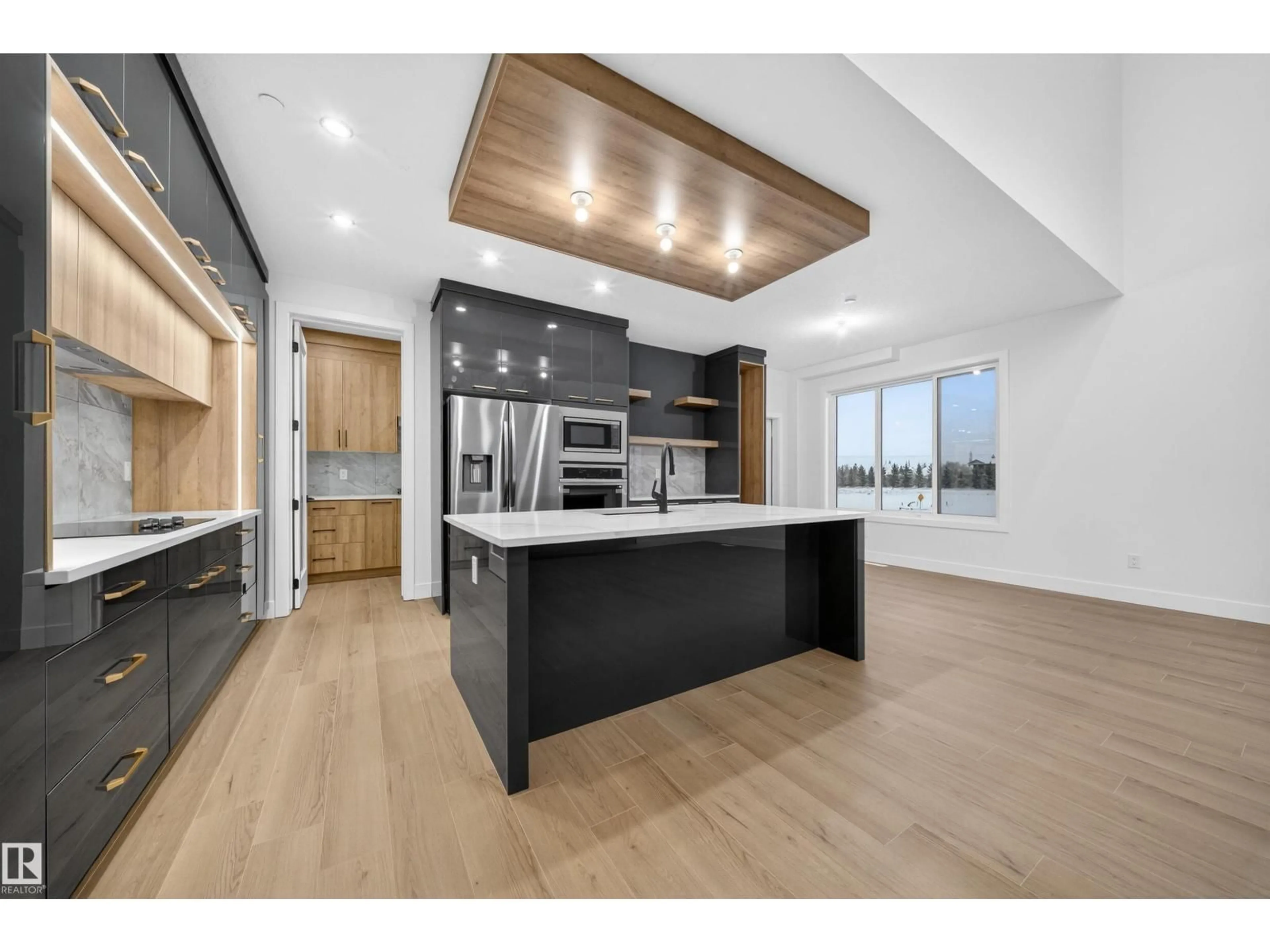 Open concept kitchen, wood/laminate floor for 5922 19 ST, Rural Leduc County Alberta T4X3C4