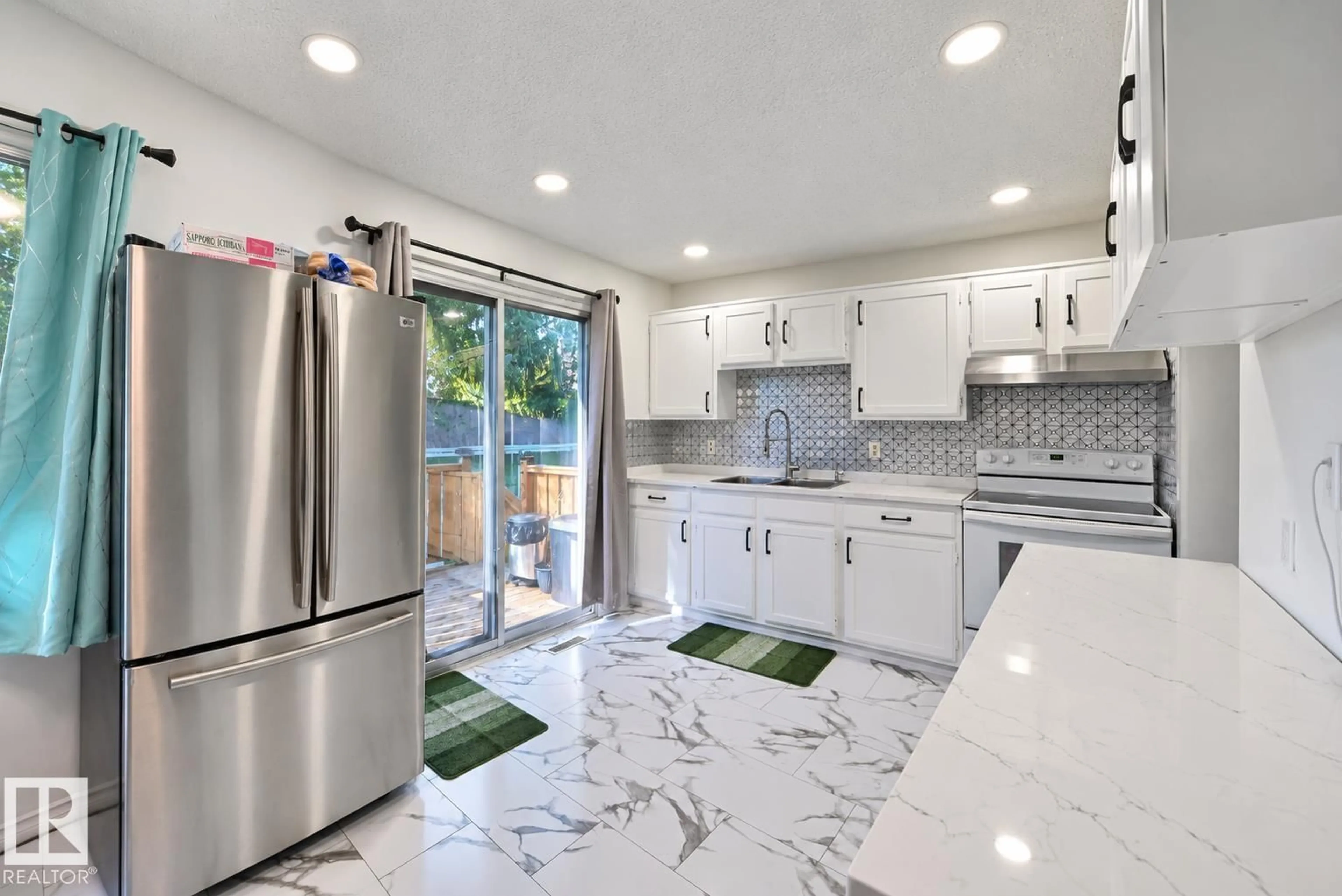 Open concept kitchen, ceramic/tile floor for 14240 23 ST, Edmonton Alberta T5Y1E8